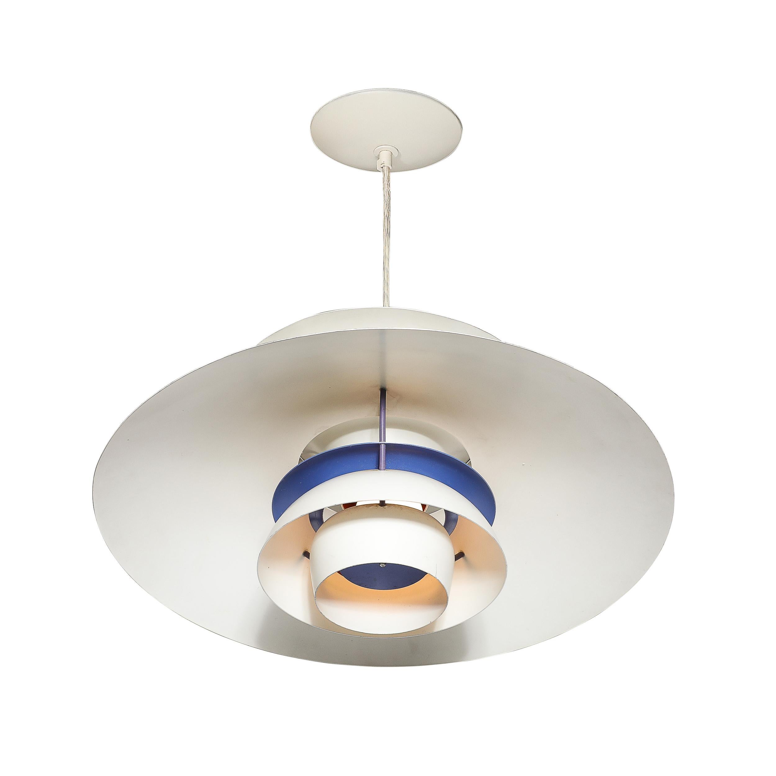 Illuminate your space with this Mid-Century Modernist PH5 Pendant Chandelier. Designed by Poul Henningsen for Louis Poulsen in 1980, this exquisite piece exemplifies Danish lighting design.
The chandelier features a sophisticated white enamel