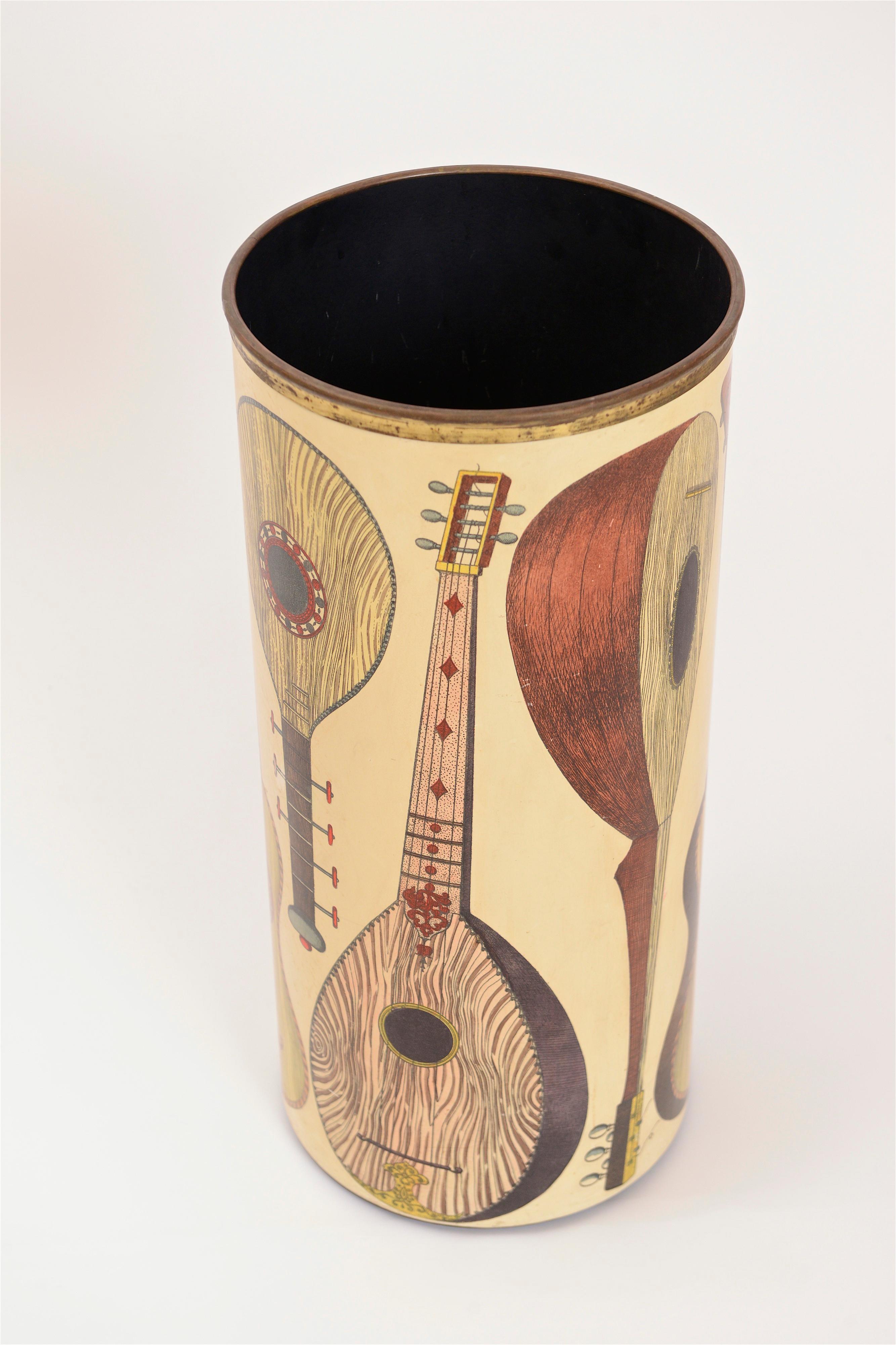 A beautiful umbrella stand from the 1950s by Piero Fornasetti. This ‘instrumenti’ model is decorated with eight lithographic transfers of different stringed instruments. In great condition, this umbrella stand is signed on the underside