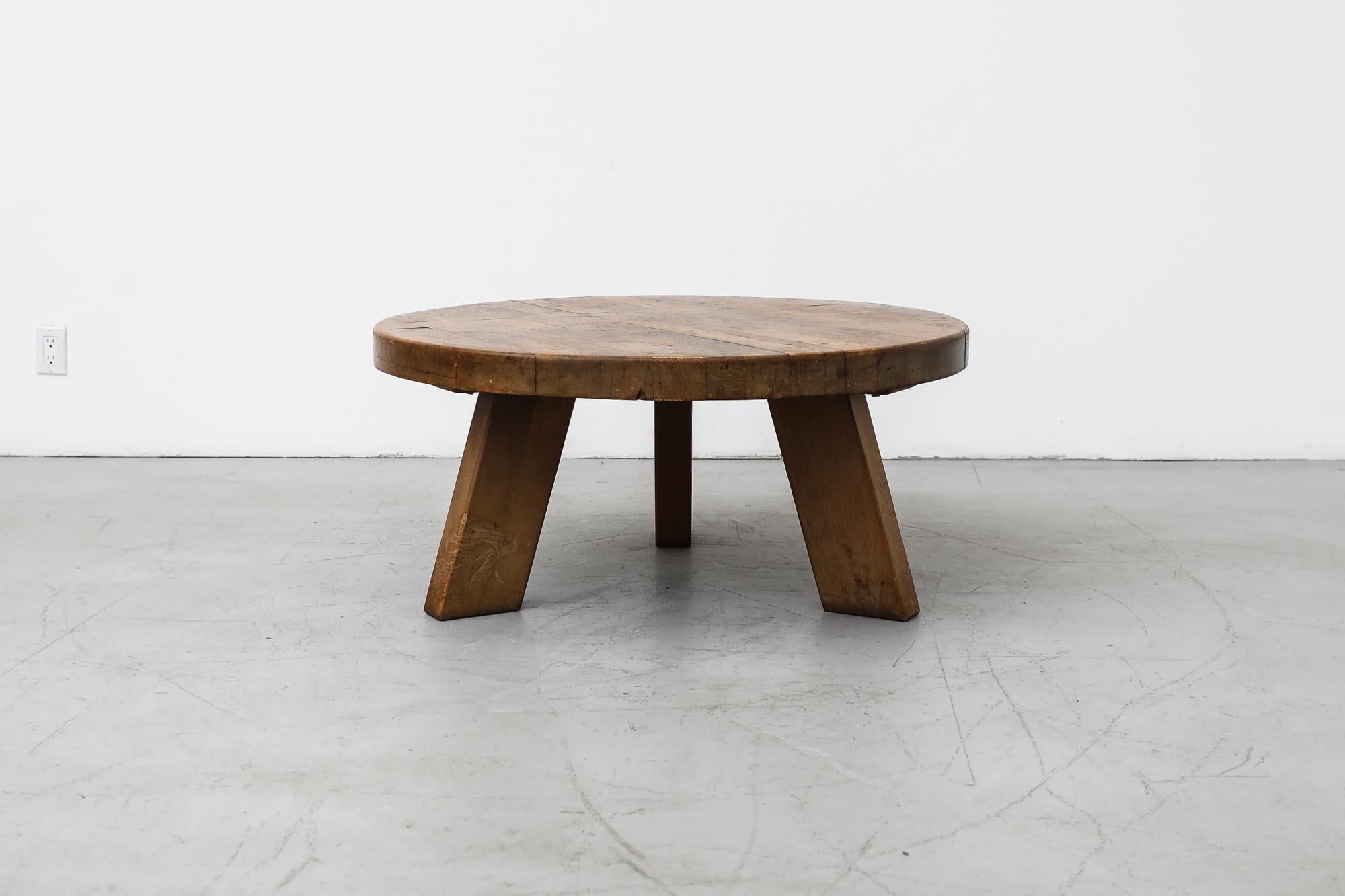 Heavy round Mid-Century Brutalist coffee or side table made from solid oak with three sturdy legs. In original condition with visible wear and patina consistent with its age and use. Similar tables also available and listed separately.