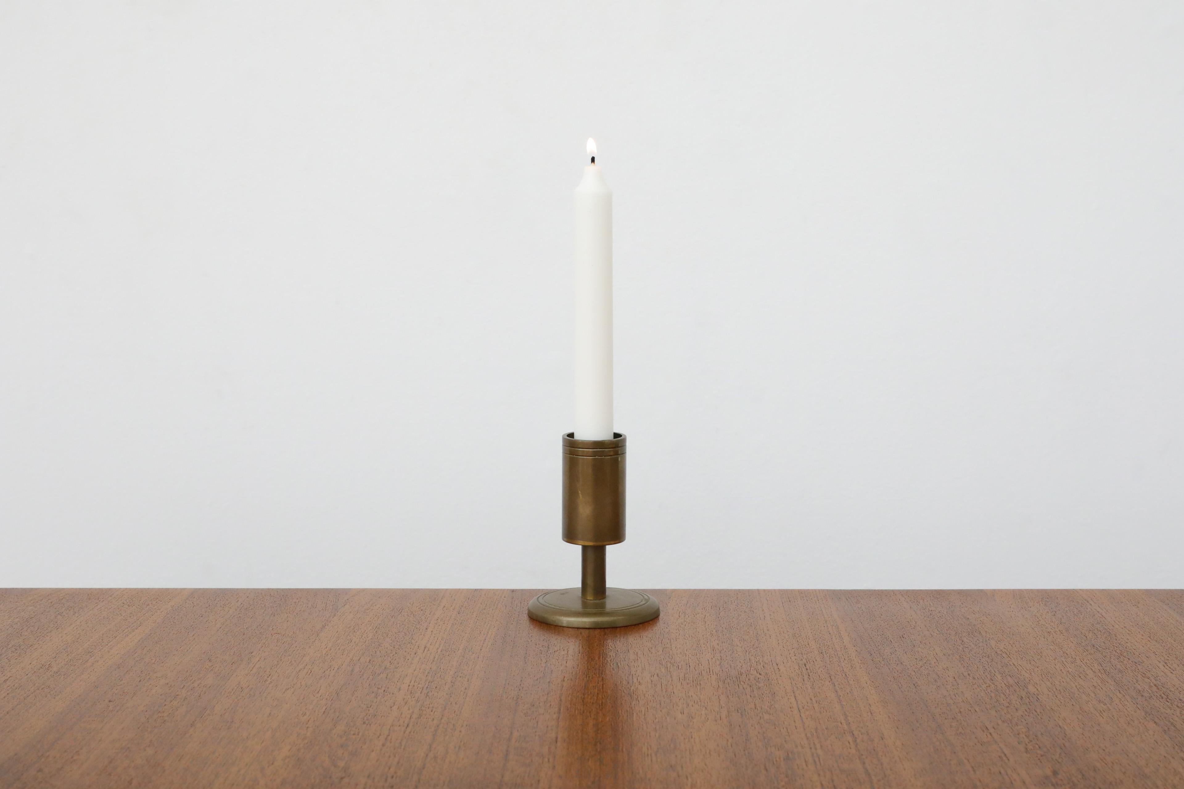 Mid-Century, Pierre Forsell style, bronze candlestick holder. Subtle minimalist attitude with a versatile look. Inspired by a traditional torch sconce, this piece combines industrial and modernist influences. In original condition with visible wear