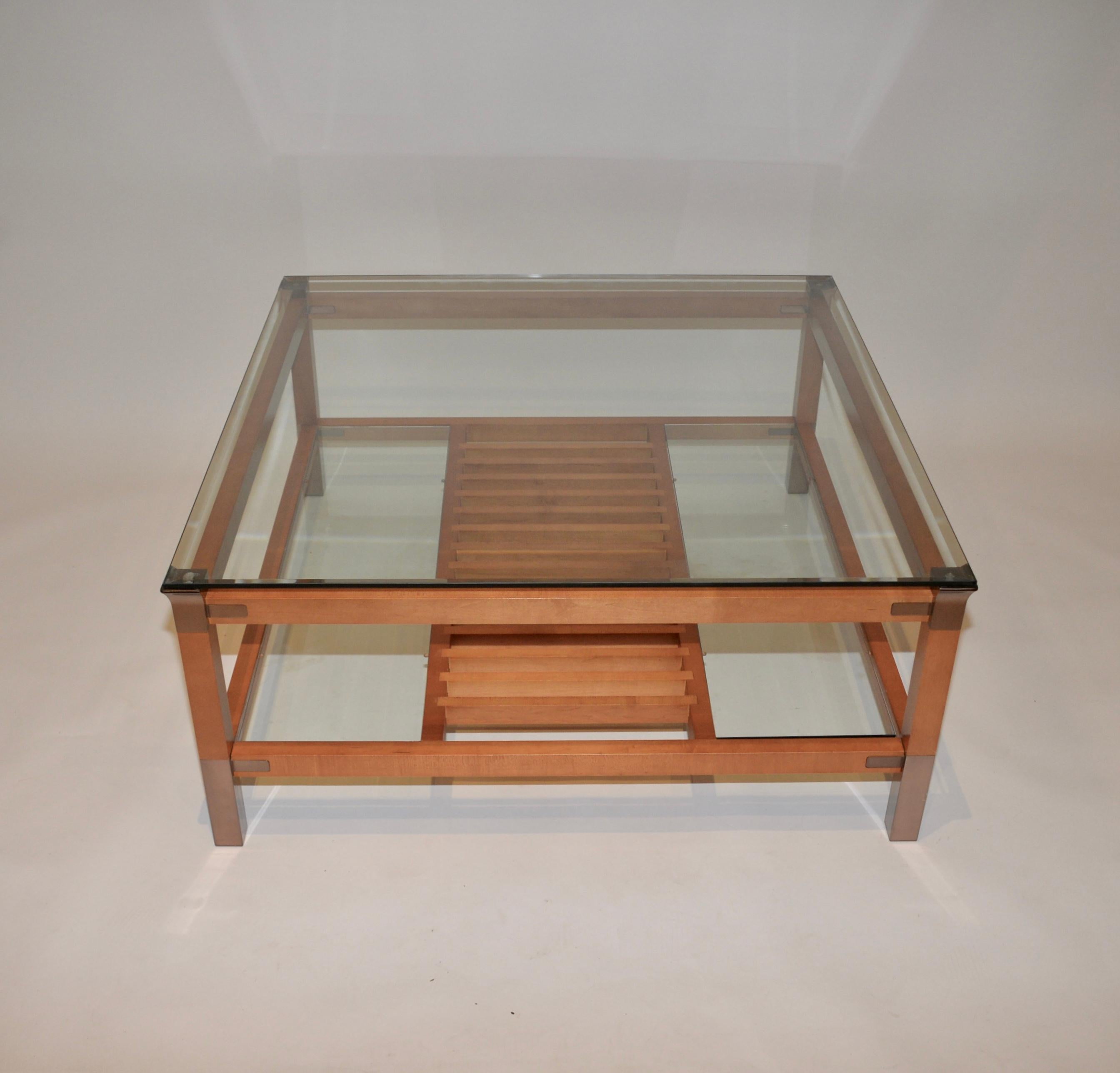 A fabulous midcentury coffee table by the iconic French designer Pierre Vandel vintage. Lovely wooden frame with a beveled glass top shelf and a slated wooden lower shelf with glass either side of the slats. Pierre Vandel pieces are Classic timeless