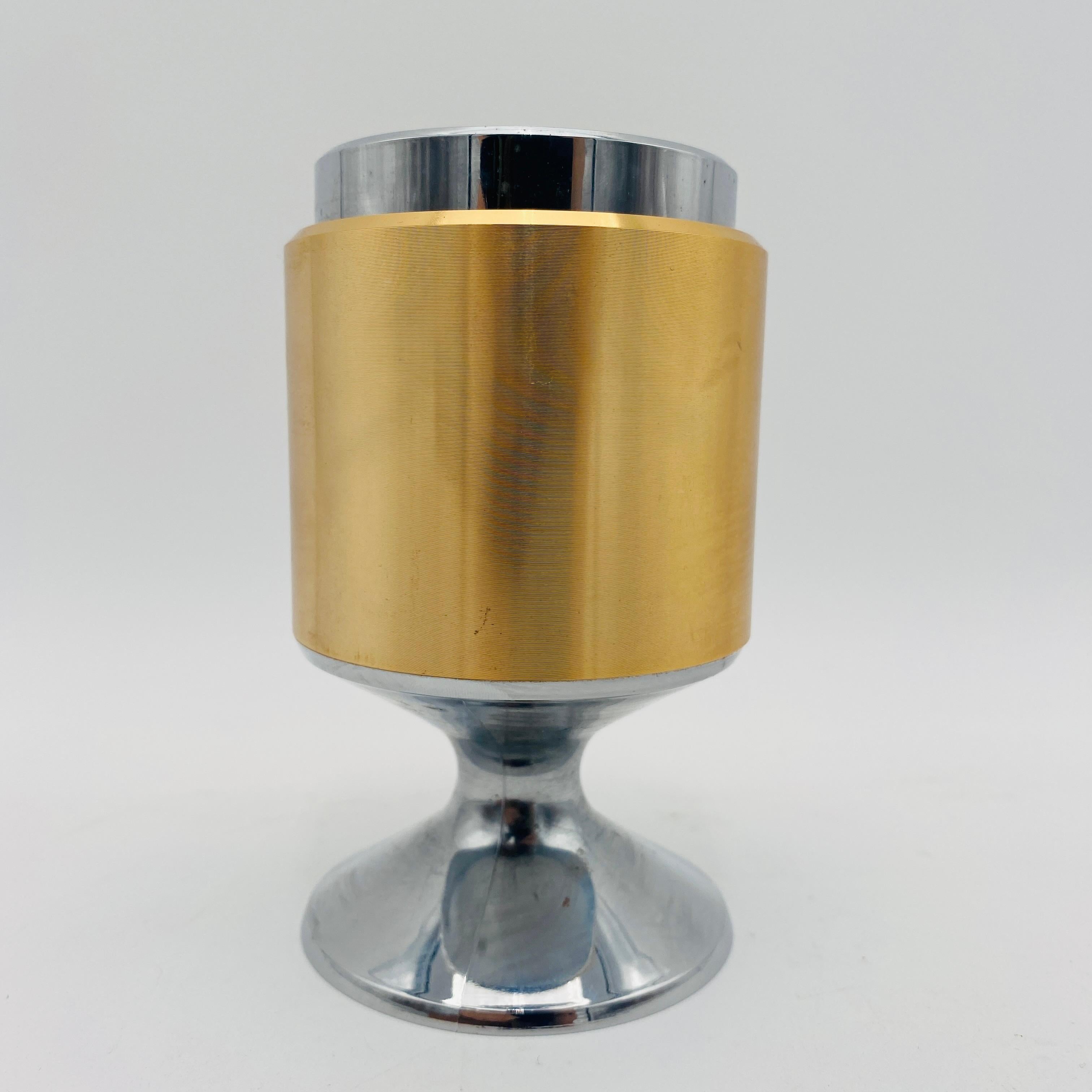 Iconic mid-century Piezo Electric Table Gas Lighter by Maruman T34. Made in Japan circa the 1960s. Sleek gold and silver with a tulip base design. To ignite the flame, you simply press down the top. The lighter does spark but will not ship with any