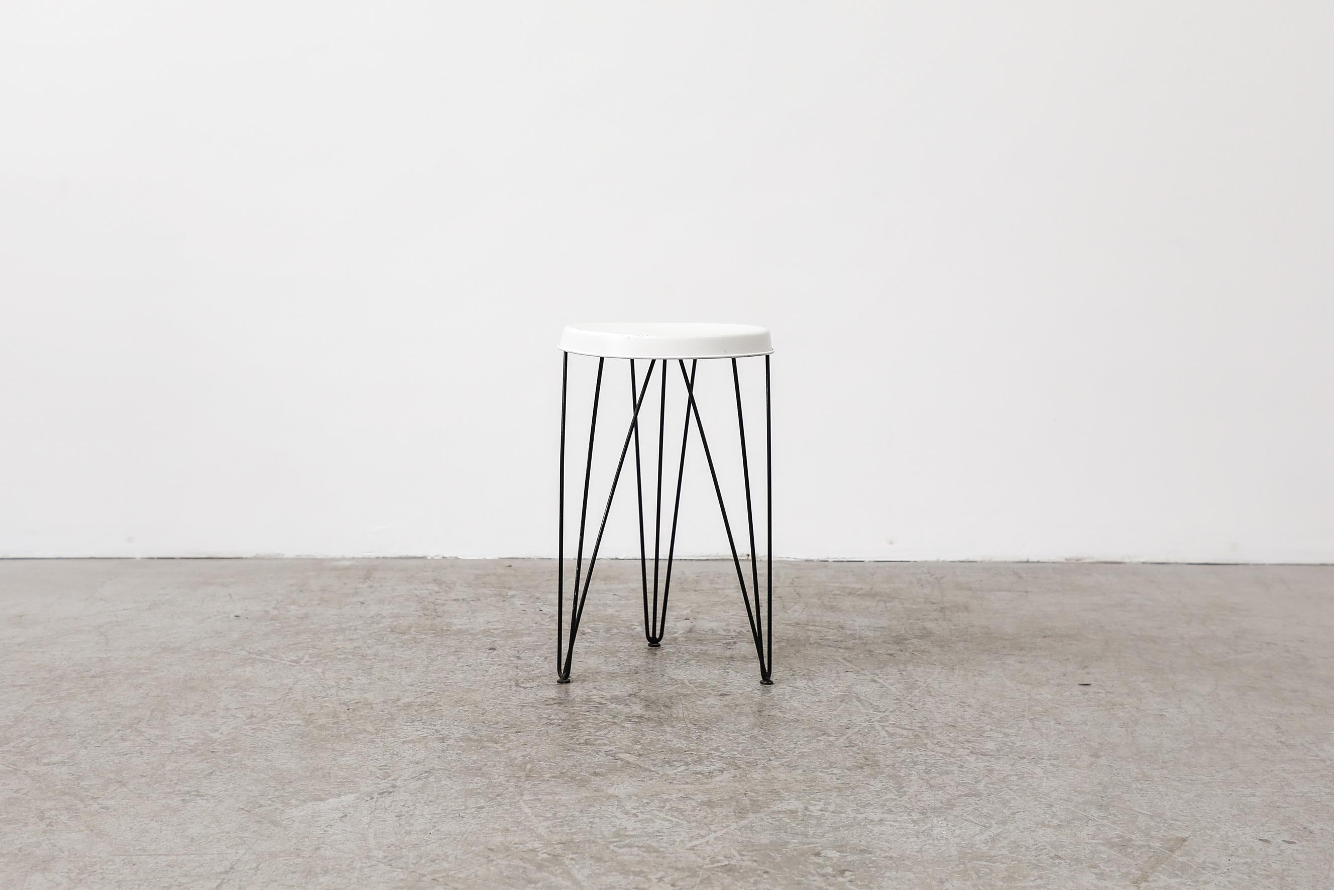 Pilastro Metal Stool with White Enameled Metal Seat and Black Enameled Wire Legs. 1950s production from the Netherlands. The frame is in original condition with visible wear including scratches and chips, the top has been touched up, but retains