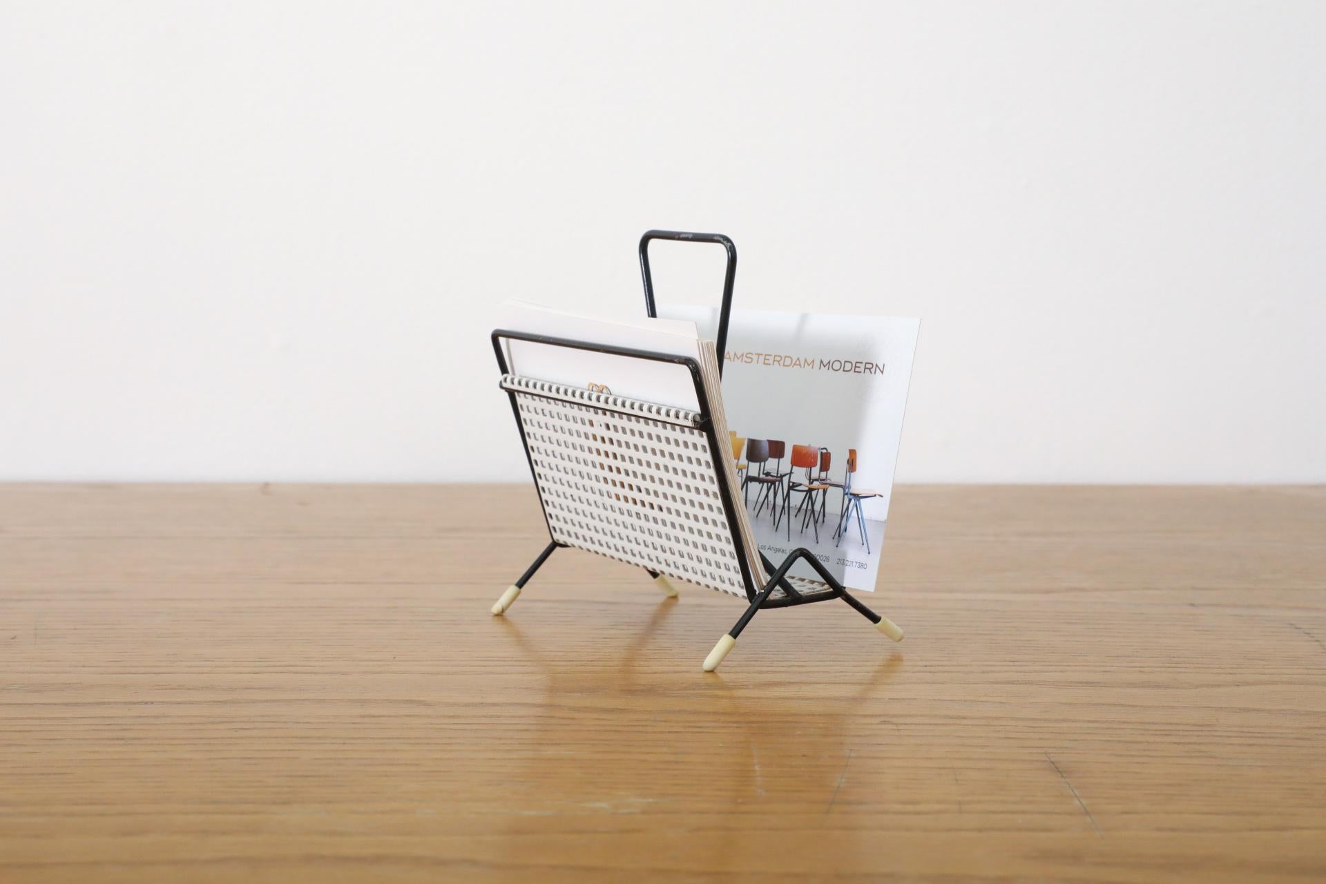 1960's white perforated metal letter holder with black enameled wire frame and little white rubber foot caps. In original condition with visible wear including some enamel loss, bending to frame and one worn foot cap.