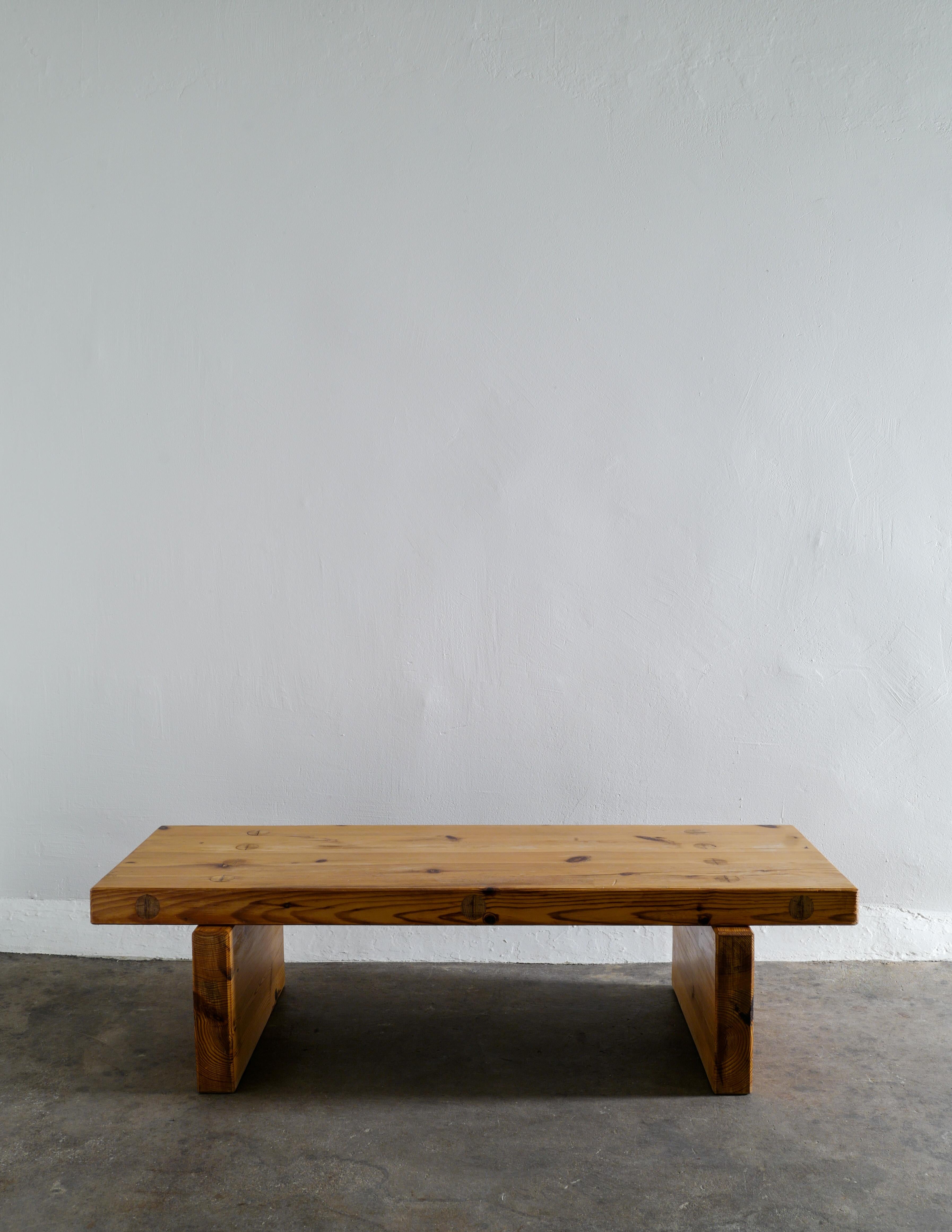 Rare mid century bench / coffee table in solid stained pine designed and produced by Roland Wilhelmsson dated March 1970. In good vintage and original condition with patina from age and use. Signed and dated. 

Dimensions: H: 35 cm W: 130 cm D: 49