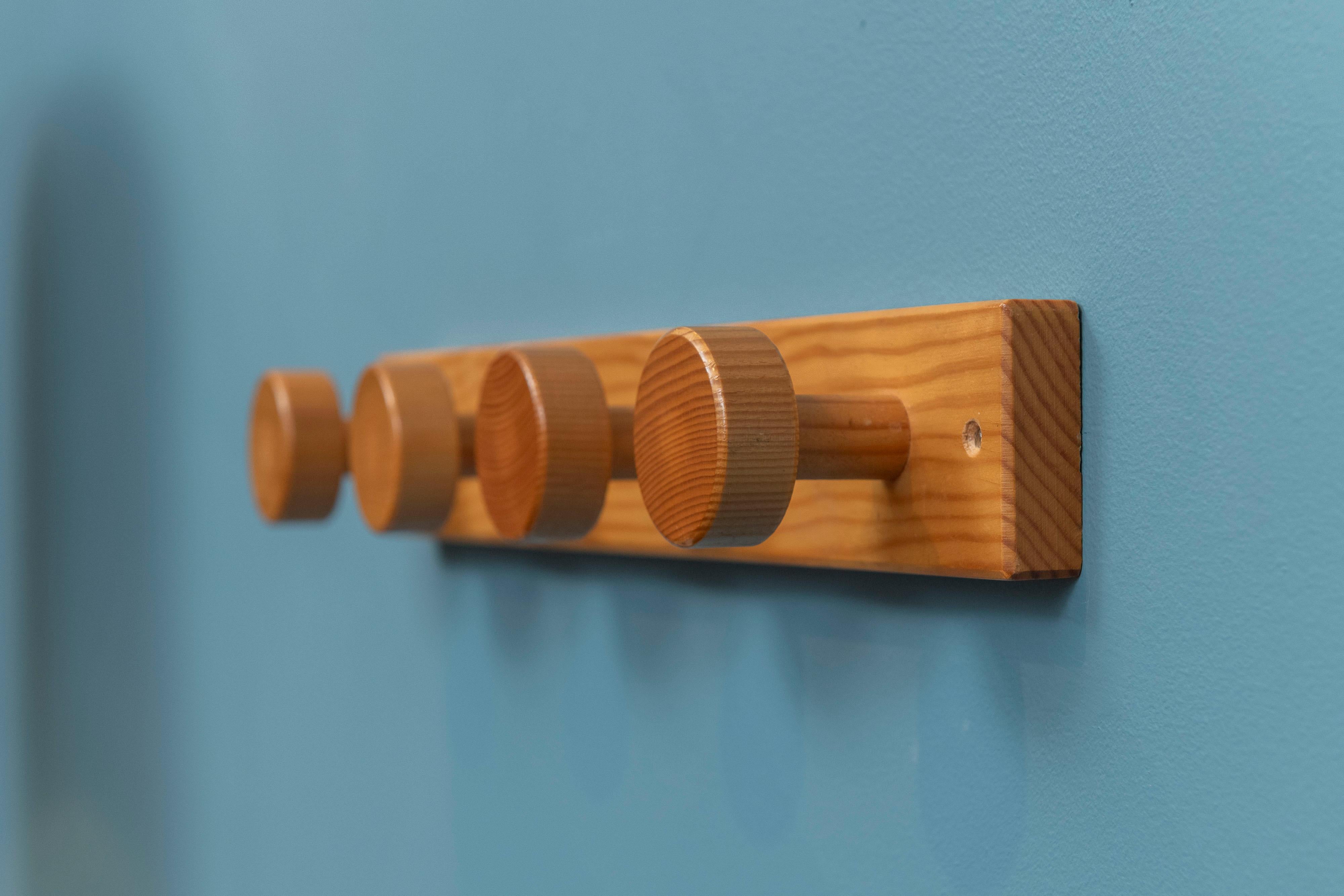 Mid-Century modern coat rack in the style of Charlotte Perriand's Les Arcs project, France. In very good original condition, requiring just two screws to hang. Made from turned pine, ready to install and enjoy.