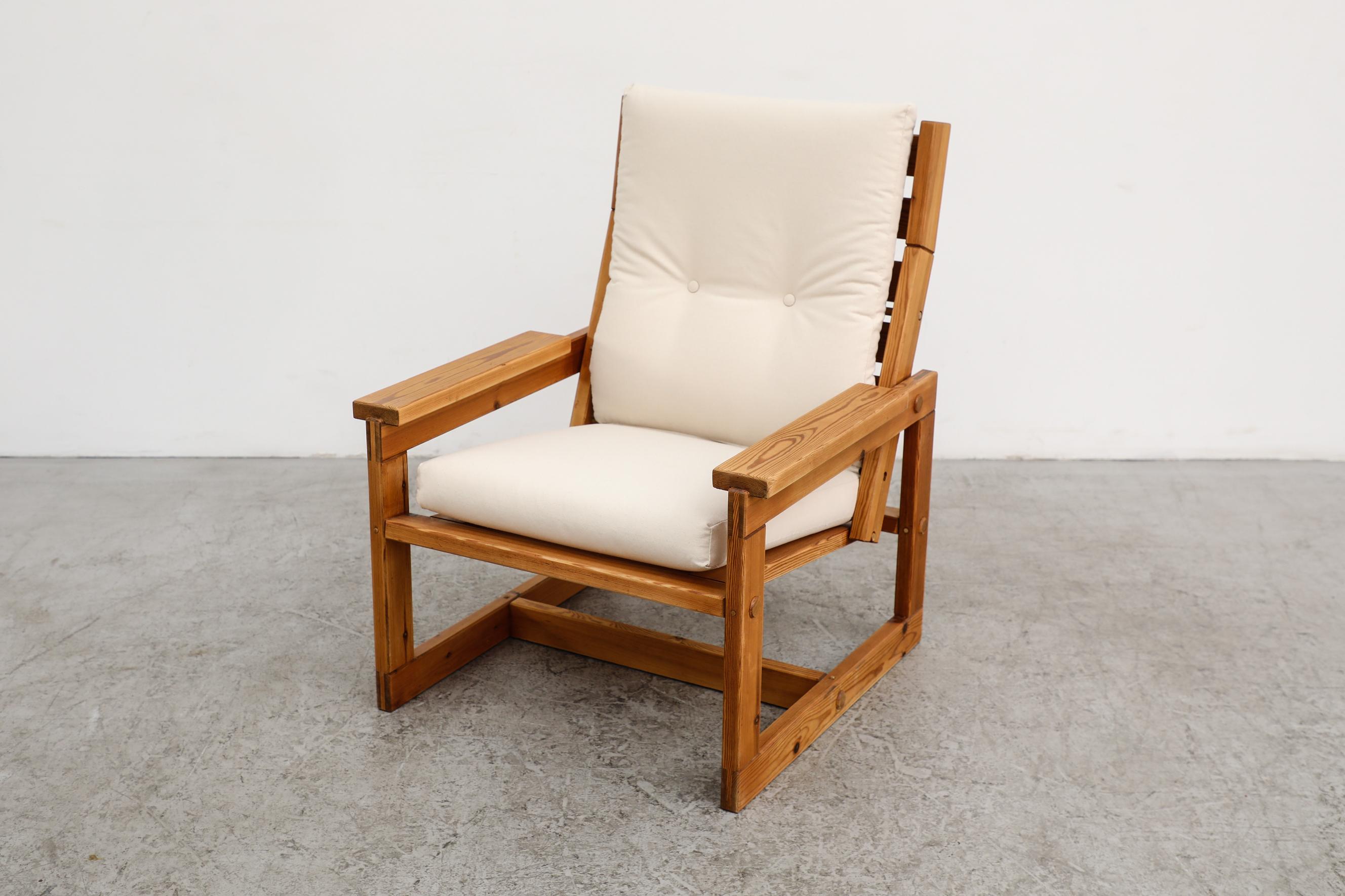 This simple crate style lounge chair in the style of Edvin Helseth whose clean and characterful expression stands as a prime example of Scandinavian design, is made from pine and has new natural canvas upholstered seating that is secured with pine