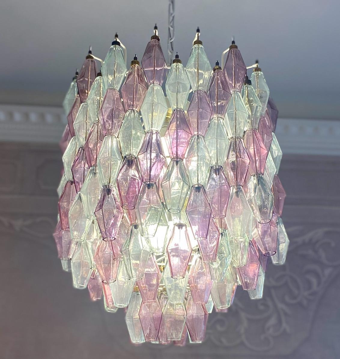 Fabulous original Polyhedral Murano glass chandelier. Rare combination pink amethyst and clear colored poliedri hanging from the metal tiers at several levels.
Ivory painted round shaped frame in very good and fully original condition.
The