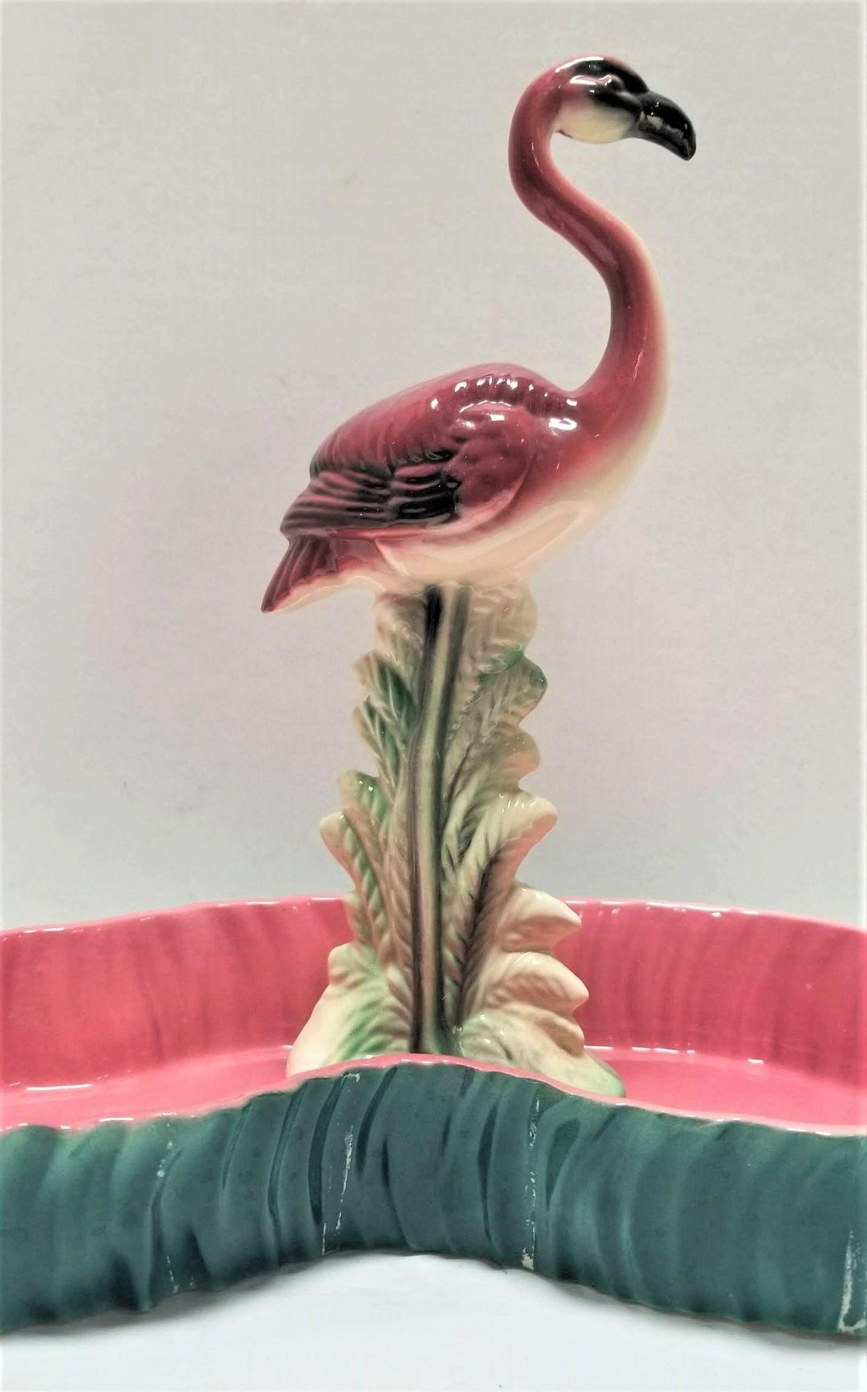 Midcentury pink and green flamingo ceramic figurine in flamingo pool tray decorative bowl.
Maddux of California was a ceramics company that operated in California from the 1930s to the 1970s. They produced a wide range of ceramic items, including