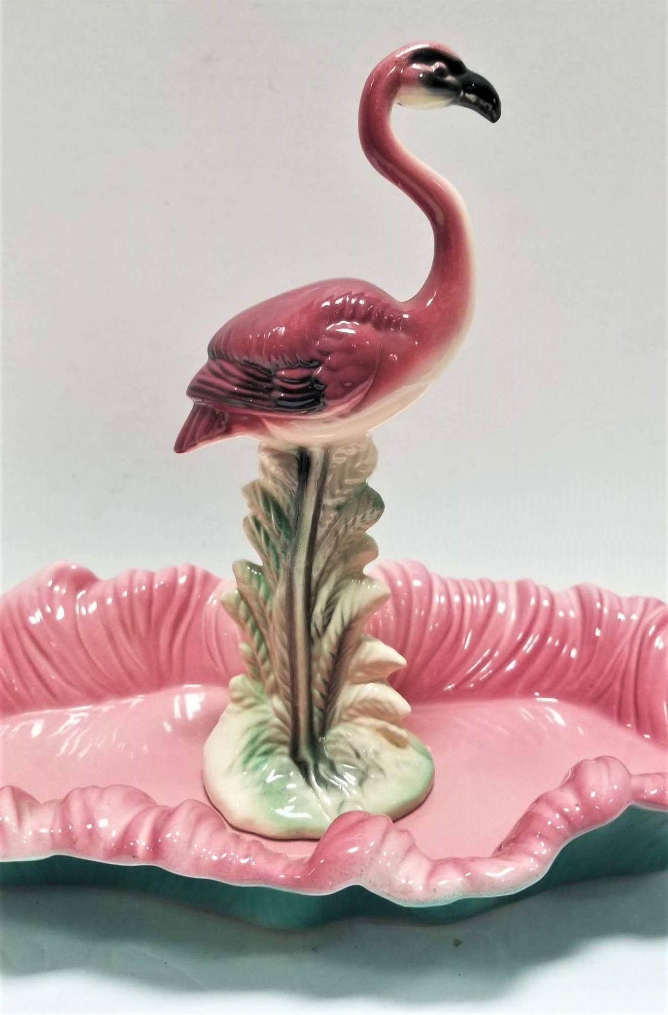 Midcentury pink and green flamingo ceramic figurine in flamingo POOL tray.
Maddux of California was a ceramics company that operated in California from the 1930s to the 1970s. They produced a wide range of ceramic items, including decorative