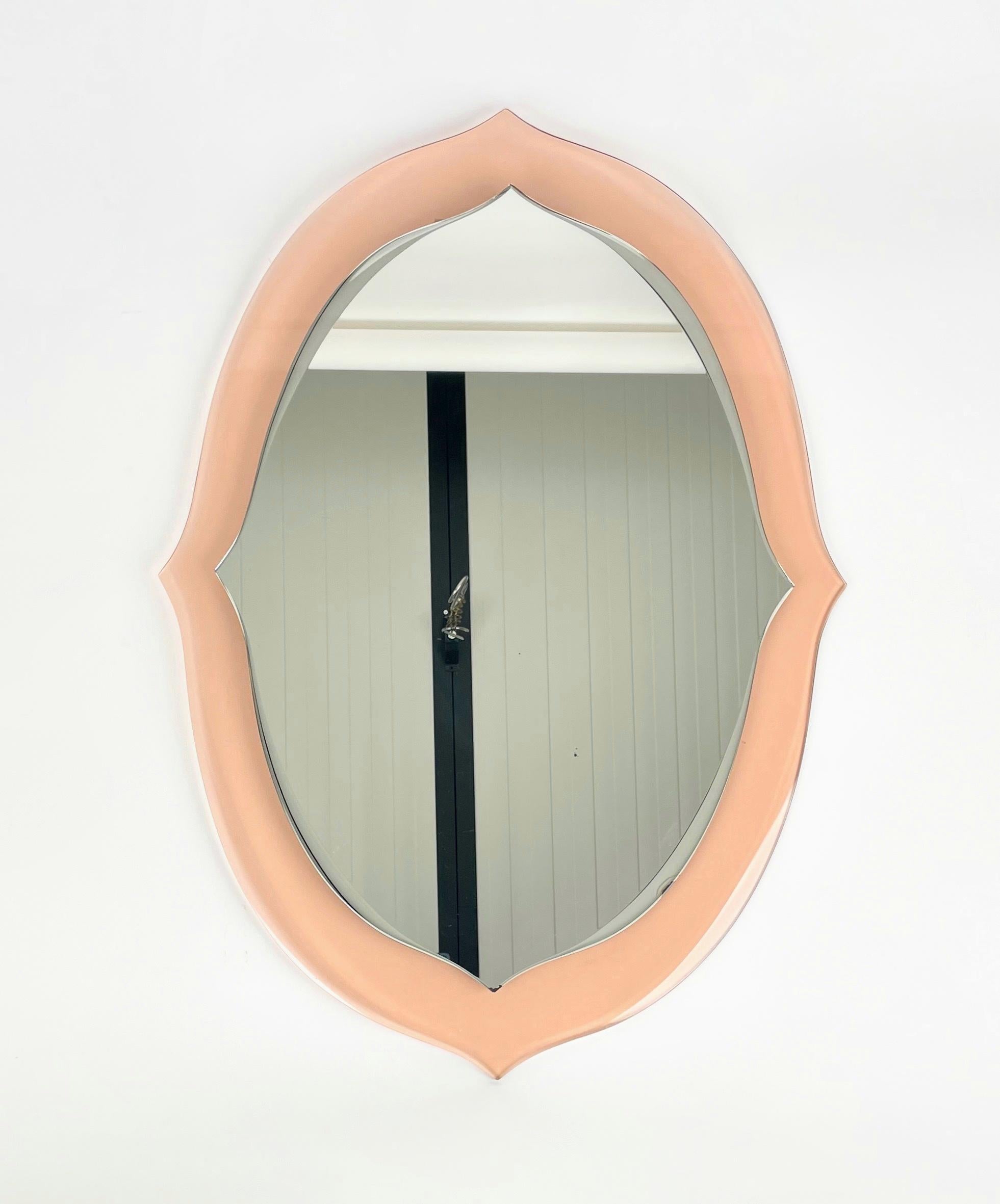 A fairy -tale mirror by shape and color, whose sinuous lines remember those of the Baroque wooden mirrors.
Produced in Italy between the 1950s and 60s, probably by Cristal Art manufacture.
It has a decoration obtained by means of the beveled on