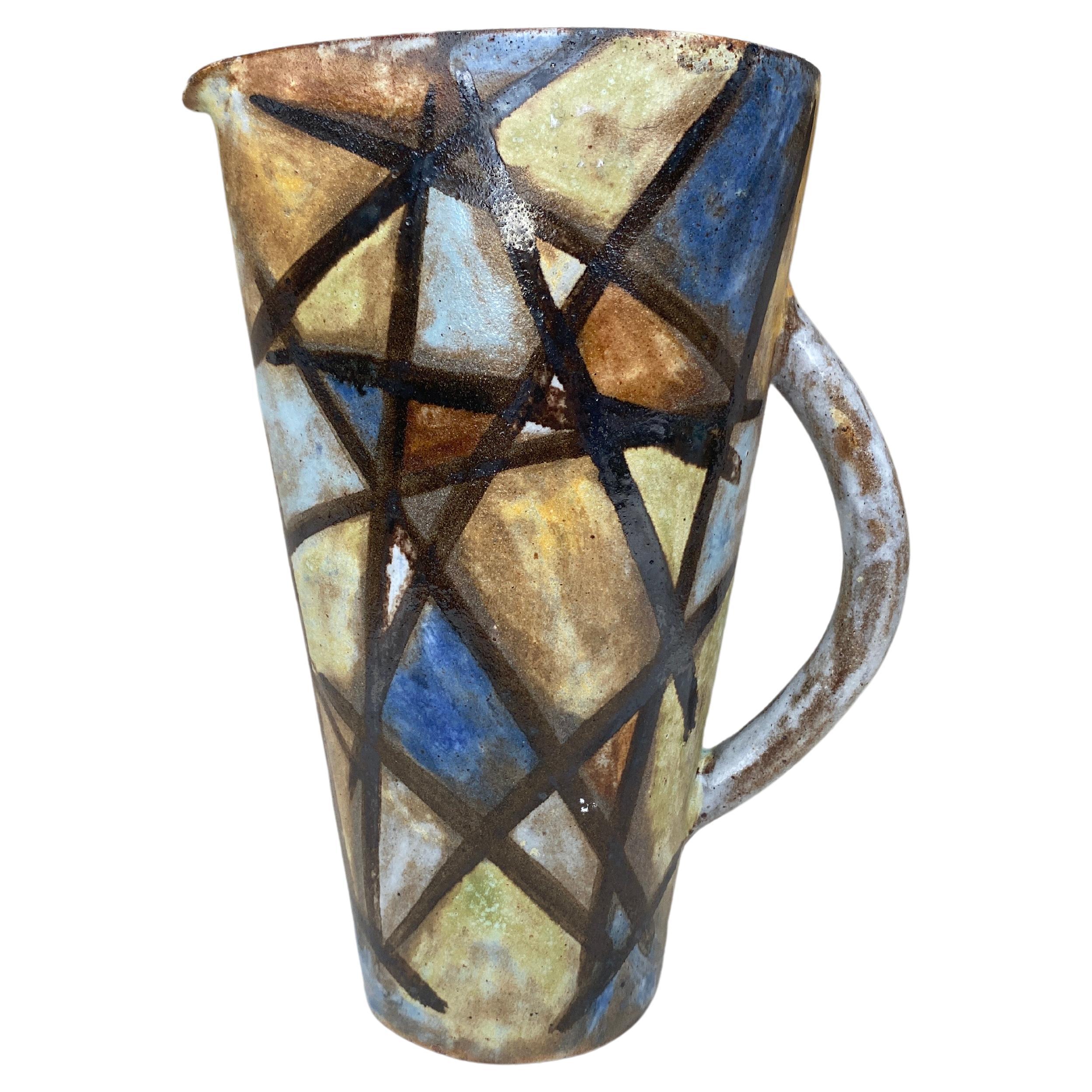 
Mid-Century geometric Abstract pitcher signed Alexandre Kostanda, Vallauris
natural clay and rustic style. Kostanda is also associated with the founding of the Accolay workshops. 
Alexandre Kostanda was an apprentice to Louis Giraud in Vallauris,