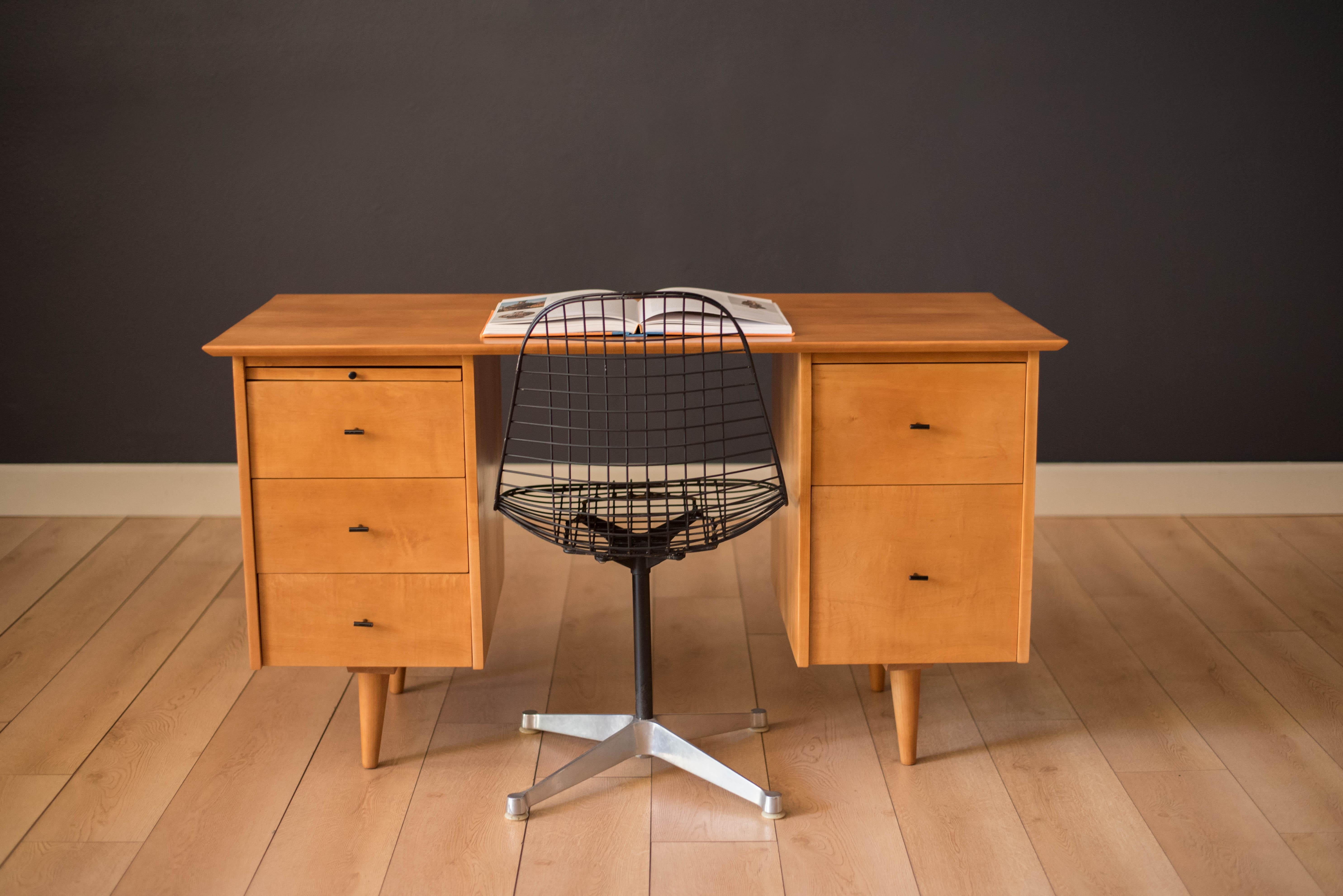 Mid-Century Modern Planner Group desk designed by Paul McCobb for Winchendon. This piece is constructed of solid birch with a natural finish. Offers plenty of storage space equipped with five drawers including a filing cabinet accessorized with