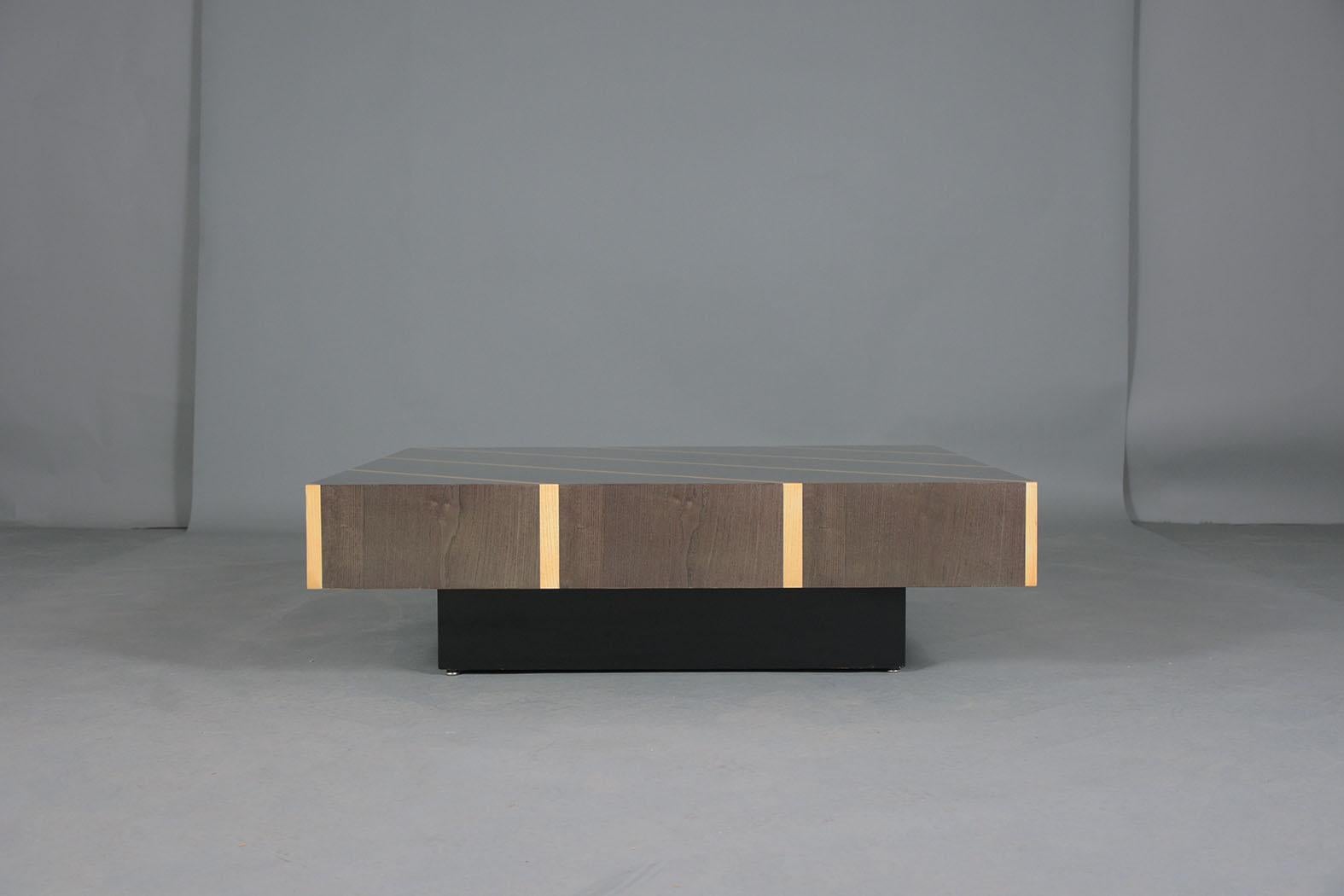 An extraordinary 1960s modern coffee table - Hand crafted wood, professionally restored by our craftsmen. This sleek cocktail table features eye-catching veneers and a beautiful lacquer finish. This table sits on a floating platform finished in an