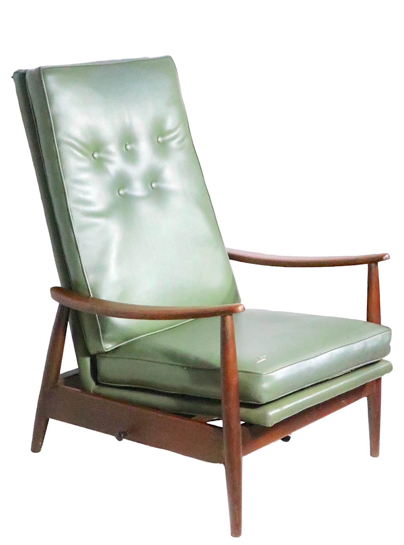  Milo Baughman for James Inc. recliner,  platform rocker, circa 1950's. This chair features a vinyl upholstered high back, and seat, an  exposed architectural wood frame. The chair is in overall good condition, fully functional and usable as is, the