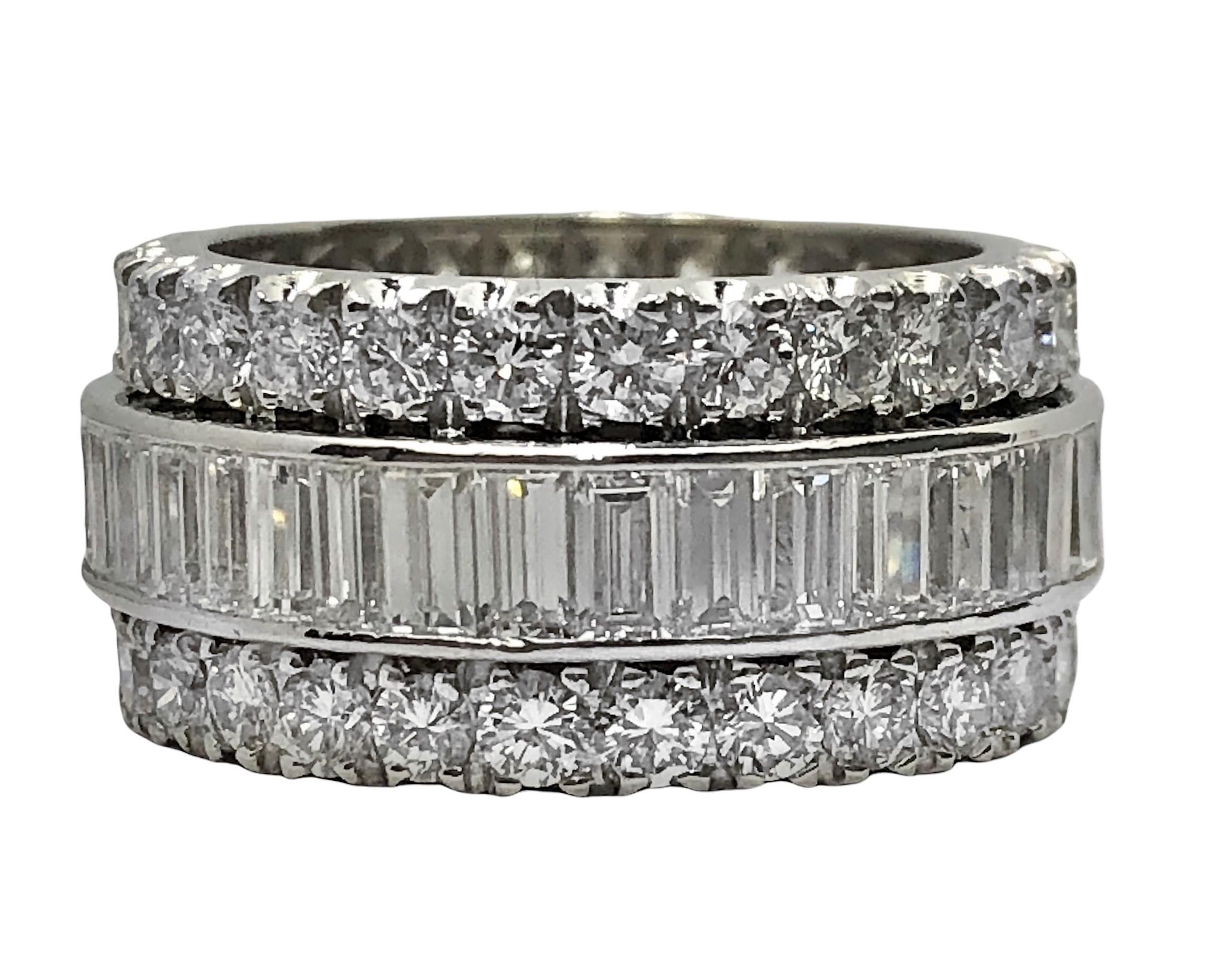 Meticulously crafted in platinum, this Mid Century, classic, 3 row eternity band is set with 2 outer rows of round brilliant cut diamonds flanking the center row of baguettes. The total approximate diamond weight is 7.75ct of overall G color and VS1
