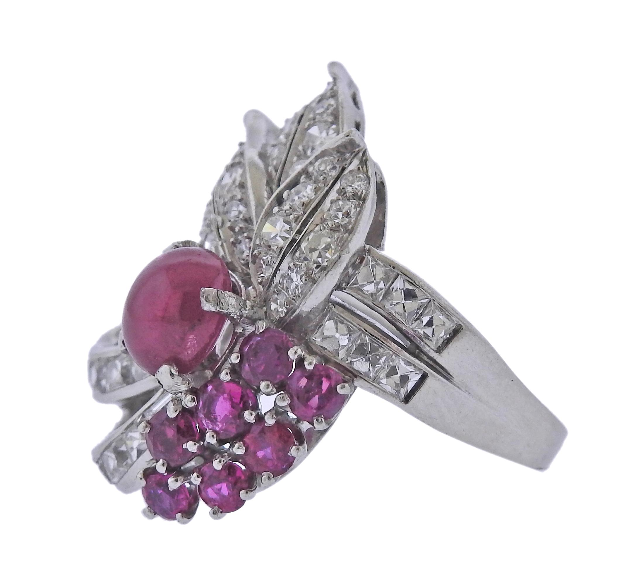 Mid Century platinum cocktail ring, with center ruby cabochon, side rubies and approx. 1.00ctw in diamonds. Ring size - 6.25, ring top - 26mm x 22mm. Tested plat. Weight - 13.3 grams.