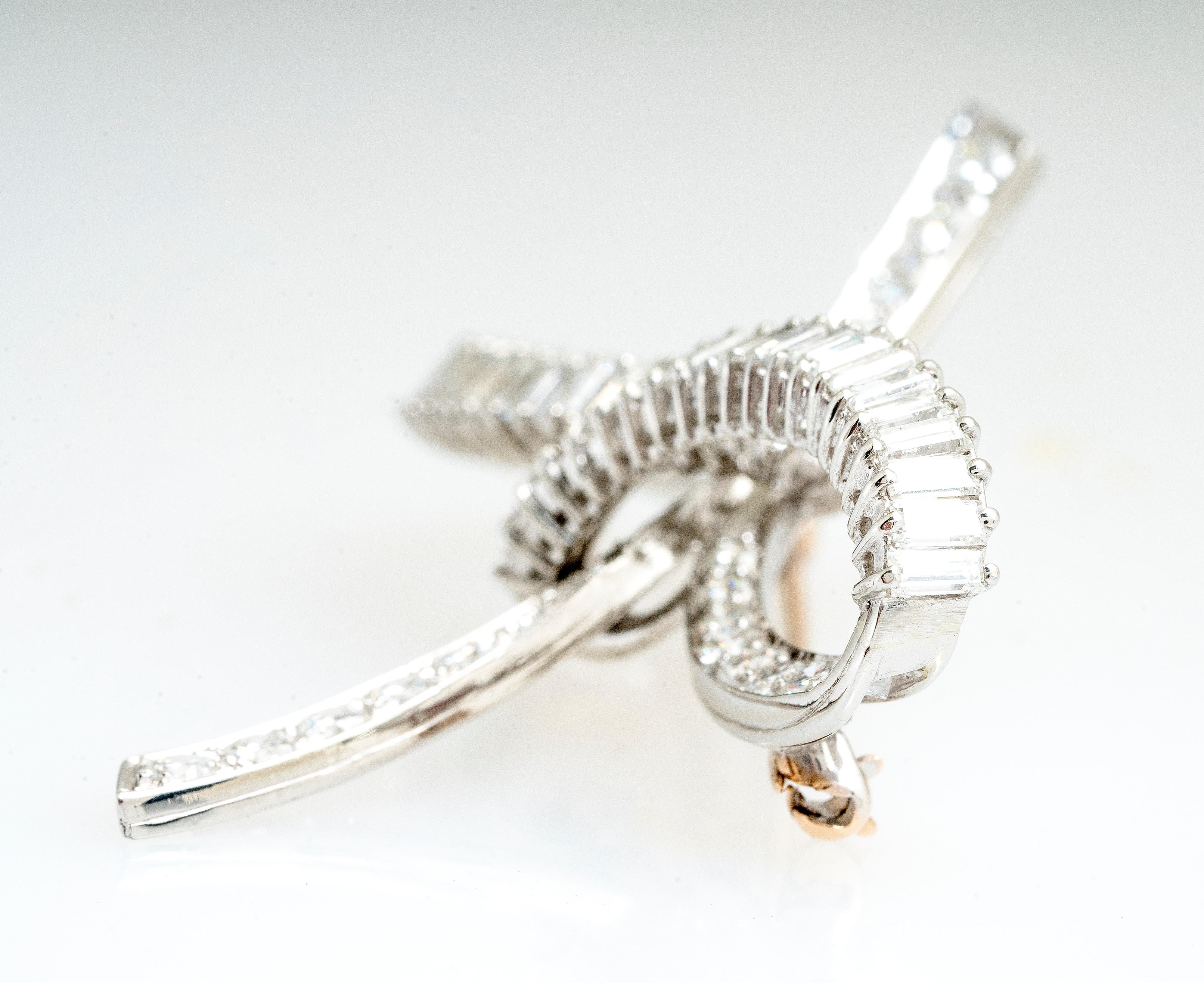 Vintage mid-century platinum rbc and baguette diamond bow brooch/pin.  There are 2.20 carat total weight of baguette diamonds  H-I color and VS2 clarity and 1.50 carat total weight of round brilliant cut diamonds H-I color and VS2-SI1 clarity. 