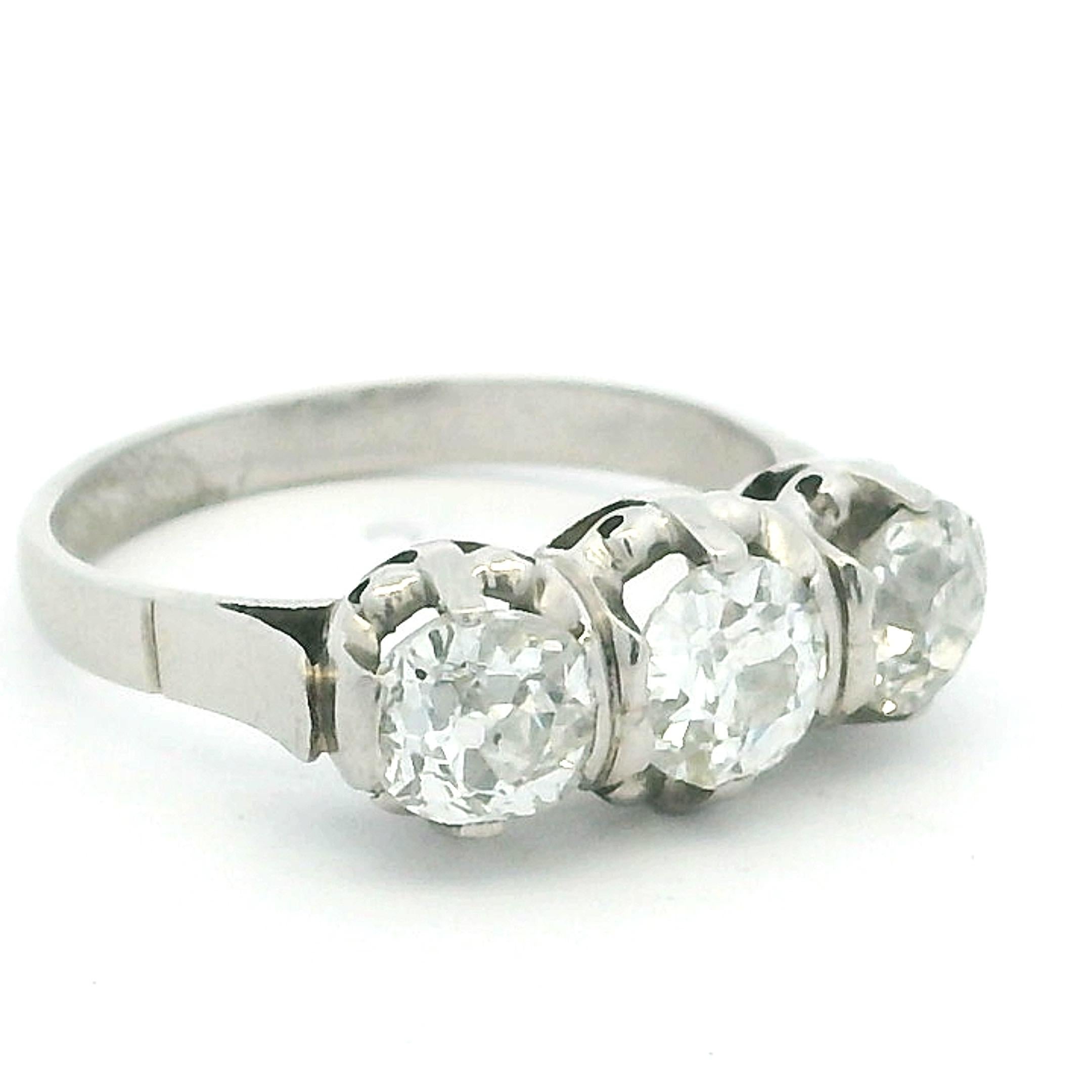 Bague raffinée et magnifiquement équilibrée en platine à trois pierres diamantées datant des années 1940/50. Cette trilogie classique présente trois diamants brillants de taille européenne ancienne sertis dans des griffes sculpturales qui mettent en
