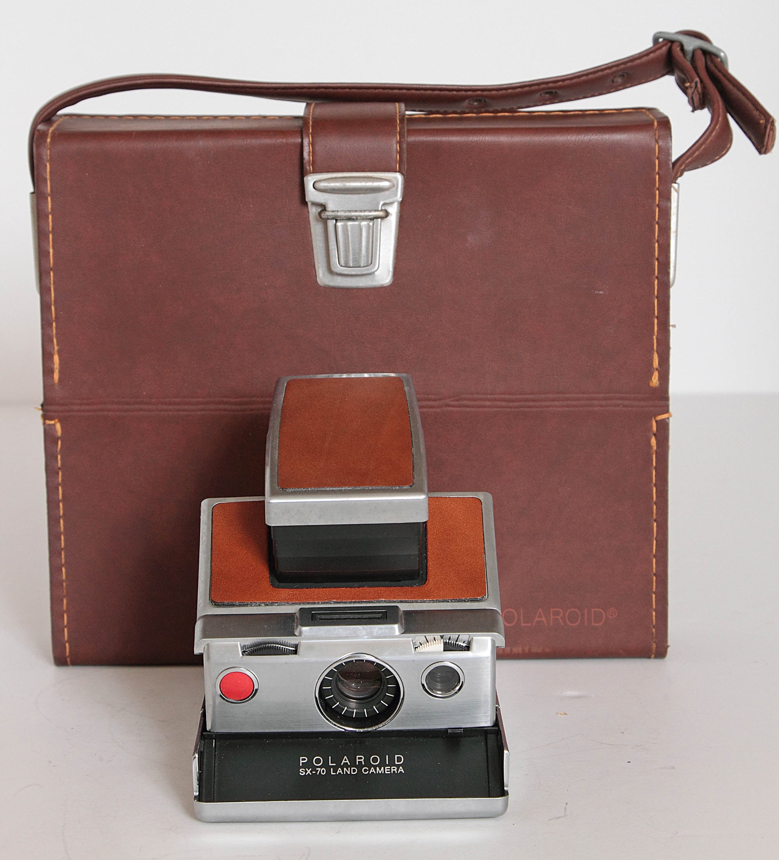 Midcentury Polaroid SX-70 land camera, with original case and accessories

The original magic camera, 1970s.
At the Polaroid company meeting in 1972, Edwin land stepped onto the stage, pulled a camera out of his jacket pocket, and took five