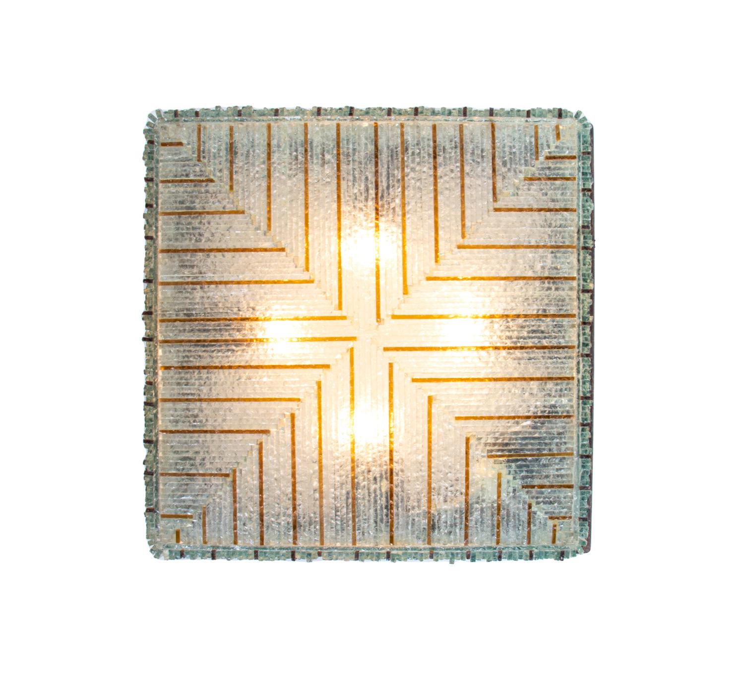Amazing heavy brutalist flush mount made of rough-cut translucent and amber glass strips mounted on a bronze frame. 
Heavy duty. With this light you make a clear statement in your interior design. Gem from the time. A real eye-catcher even unlit.