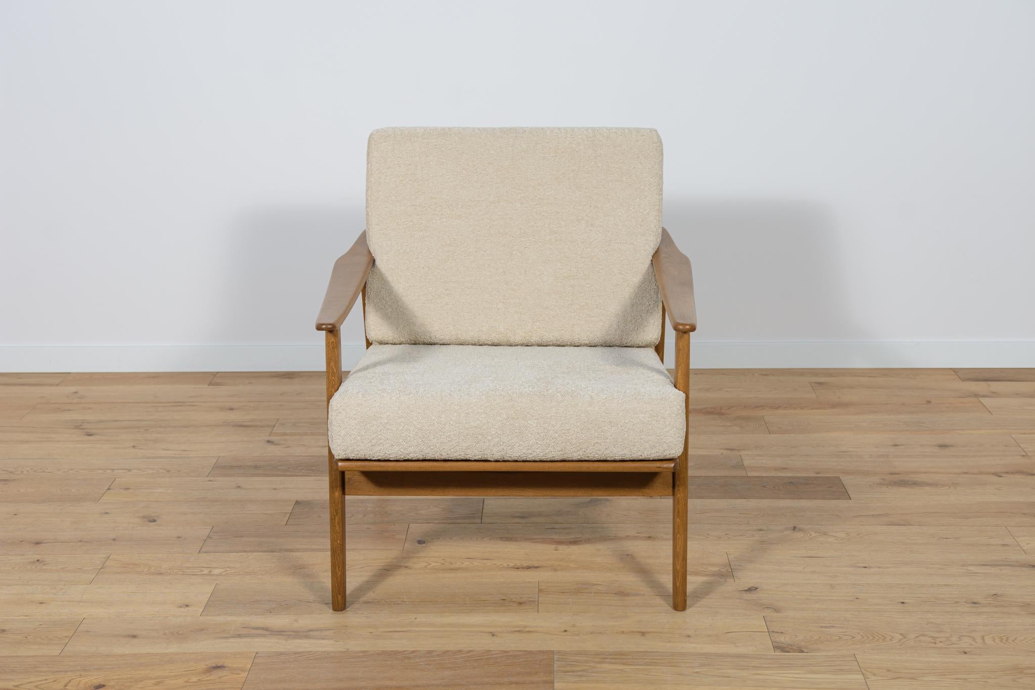 Armchair Model 5825  manufactured in the 1960s in Poland. Armchair with a unique Scandinavian form. The armchairs have undergone professional carpentry and upholstery renovation. The beech wood was cleaned from the old surface, painted with an