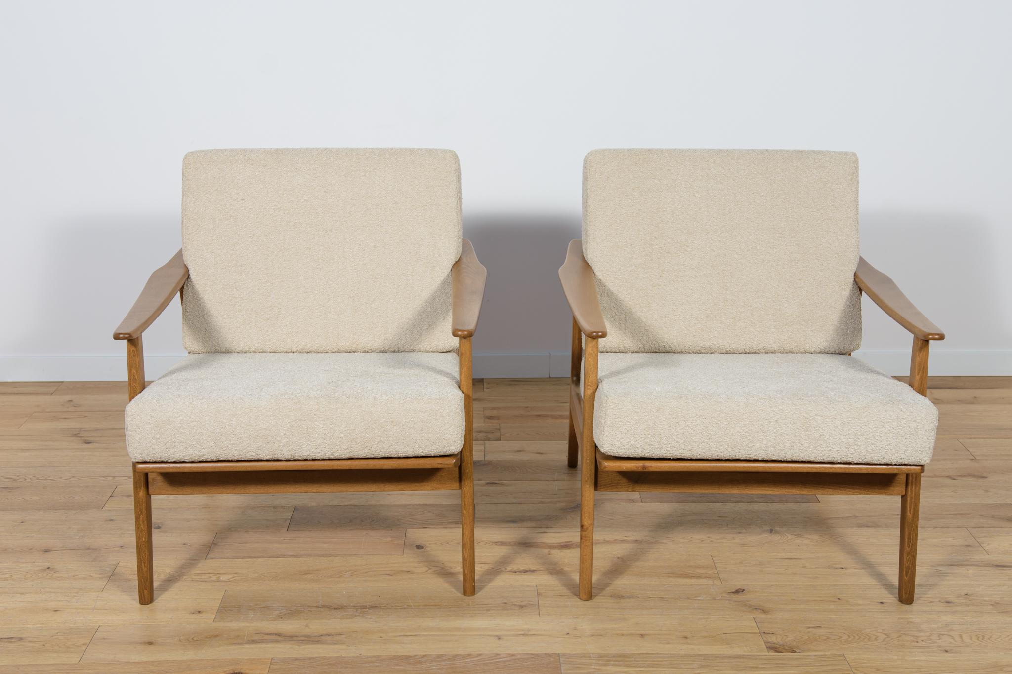 A pair of Model 5825 armchairs manufactured in the 1960s. Armchairs with a unique Scandinavian form. The armchairs have undergone professional carpentry and upholstery renovation. The beech wood was cleaned from the old surface, painted with an