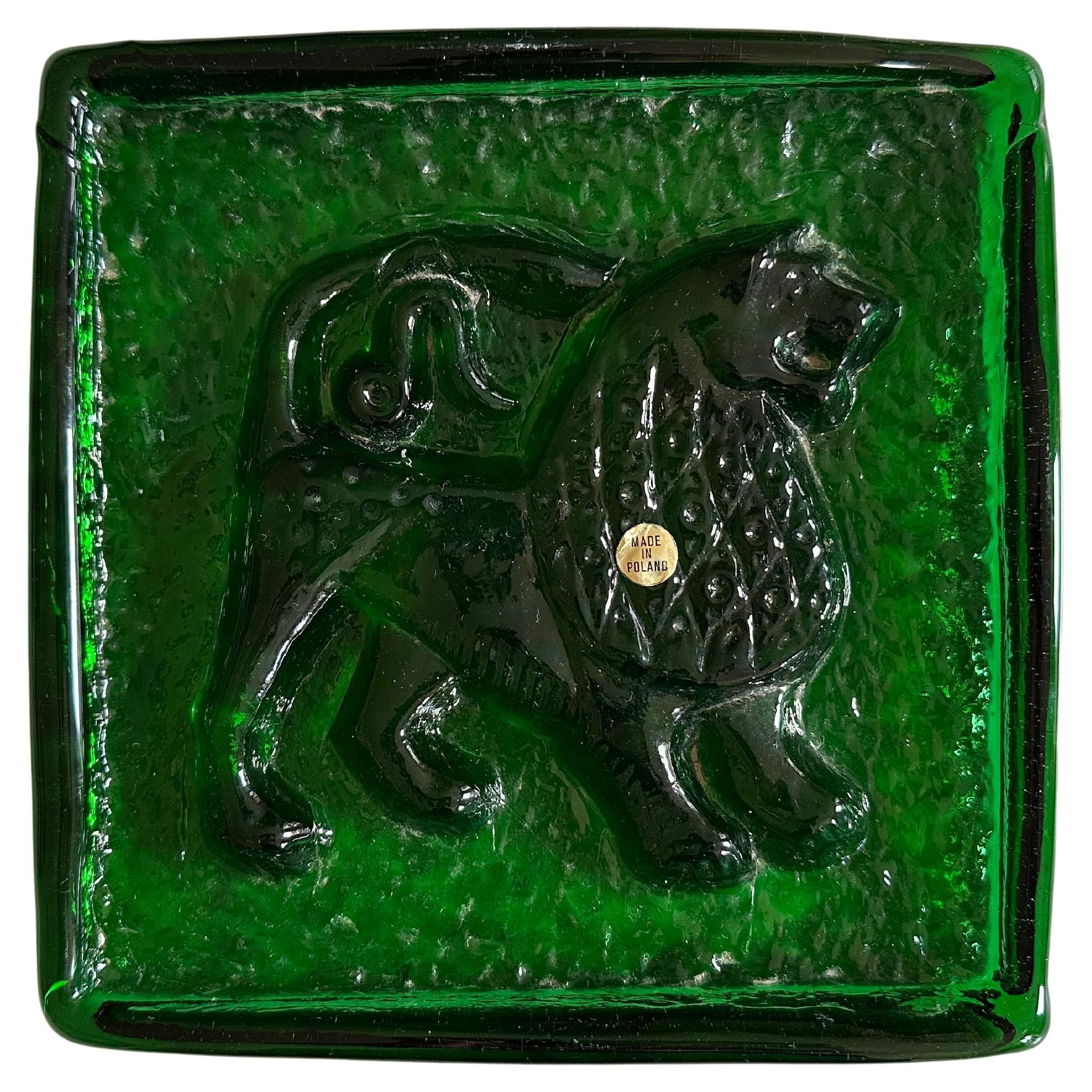 This captivating Mid-Century glass object from Poland is a beautiful representation of 1950s design. Crafted from solid, cast colored glass, the piece is rectangular in shape and reminiscent of a glass brick. The front showcases an artistic relief