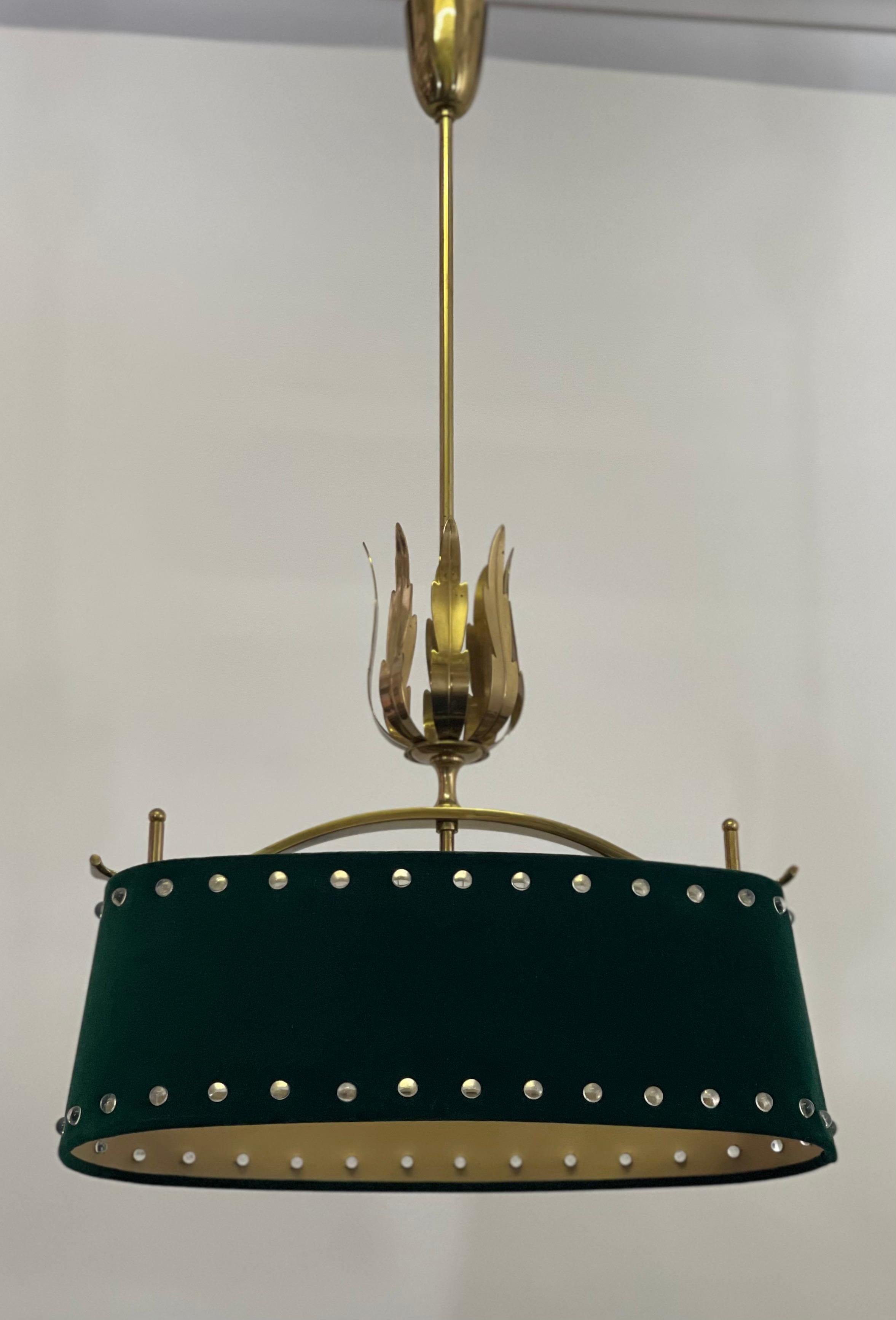 A mid-century, two-light brass chandelier with dark green felt shade, circa 1950s.
Measurements: Height 43.46, width 20.07, depth 10.62.
Socket: 2 x E27 Edison for standard screw bulbs.
 
 
   