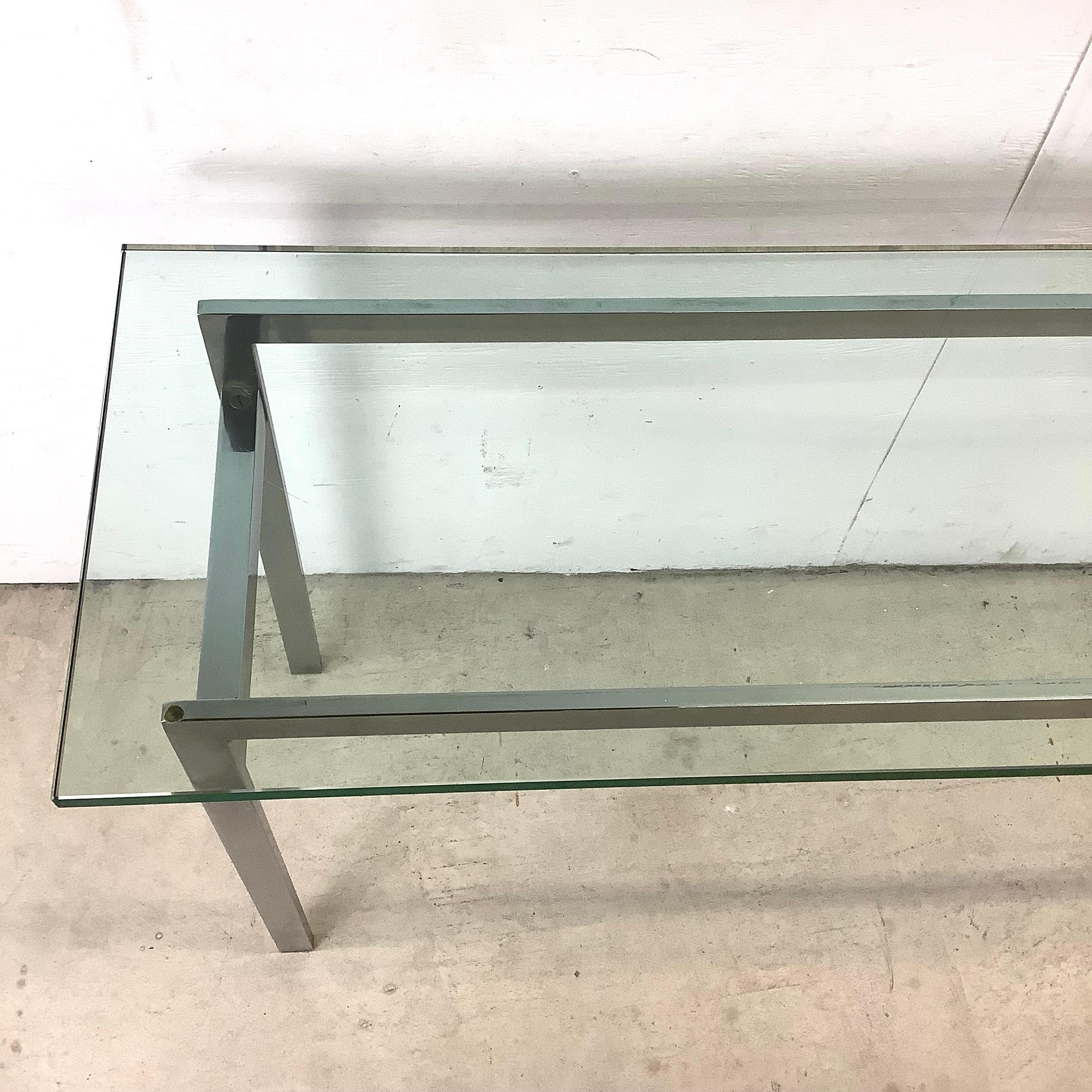 This mid-century console table features elegant milo baughman style design in a simple yet stunning combination including heavy polished steel frame and thick glass top. Perfect table for entryway display, sofa table, or any other space in need of a