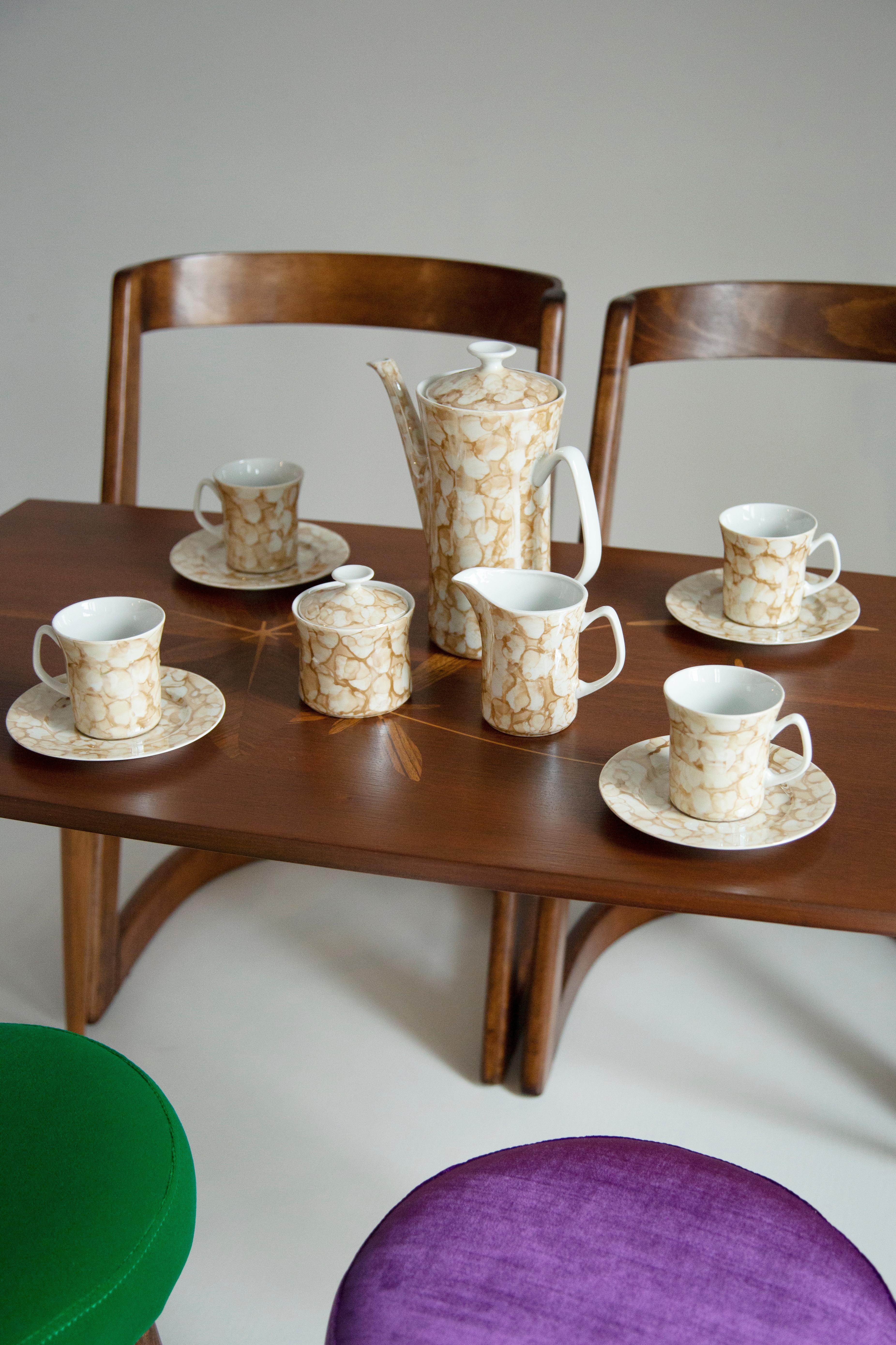 Lovely Mid-Century Modern porcelain painted marble coffee set. 

Service for 6 people produced by Zaklady Porcelany in Wloclawek in the 1960s.

The service consists of a jug, sugar bowl, creamer, 6 cups and 4 saucers. 
Two plates are