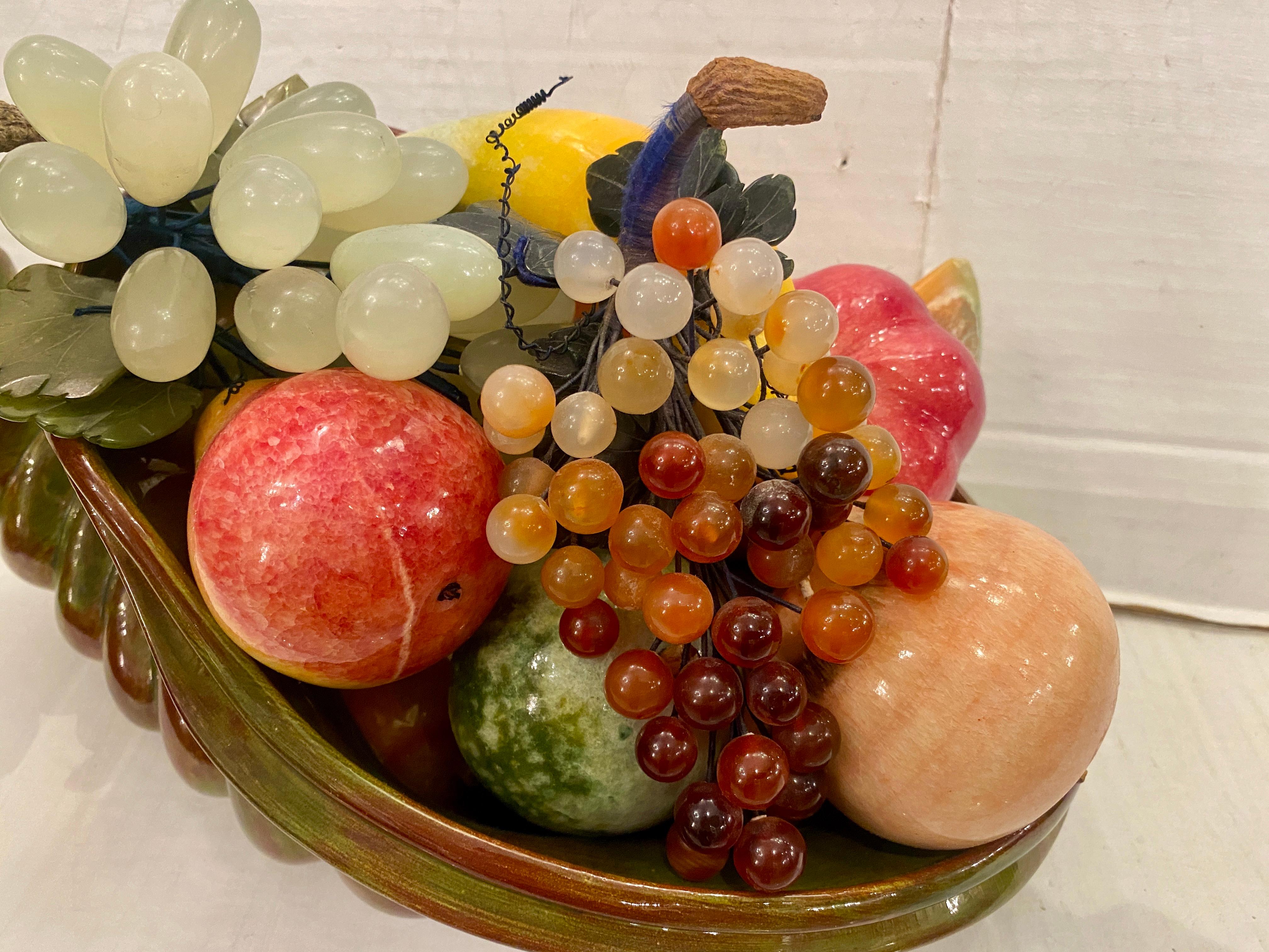 A set of circa 1950's Italian alabaster, jadeite and other stones carved into fruit in a glazed porcelain cornucopia. Sold as one item.

Measurements:
Length: 15