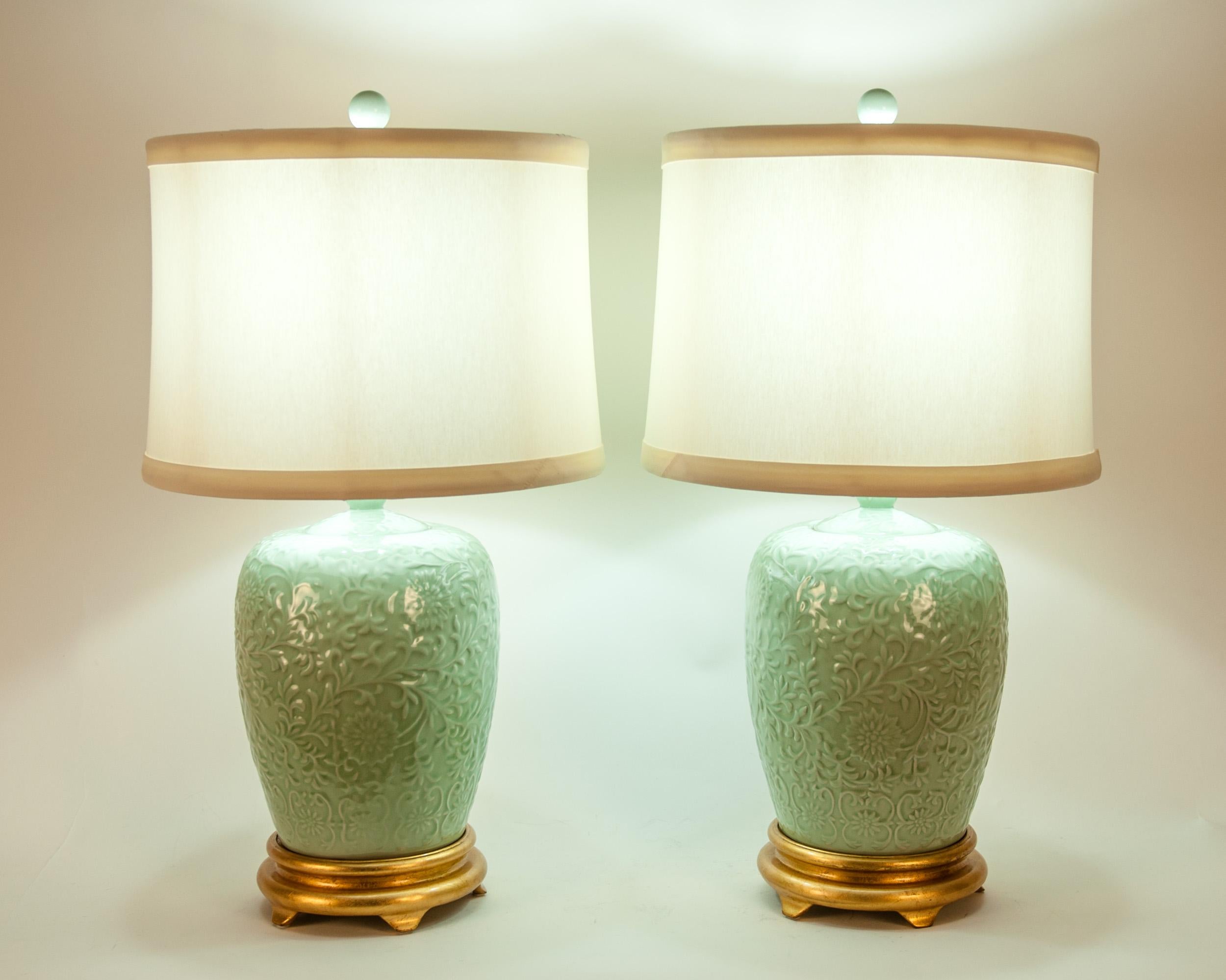 Mid-Century Modern porcelain pair table / task lamps with giltwood base. The lamps are in great working condition. Rewired for US use & regilt base. No special light bulb required. Each lamp stand about 27 inches height x 10.5 inches diameter. Each