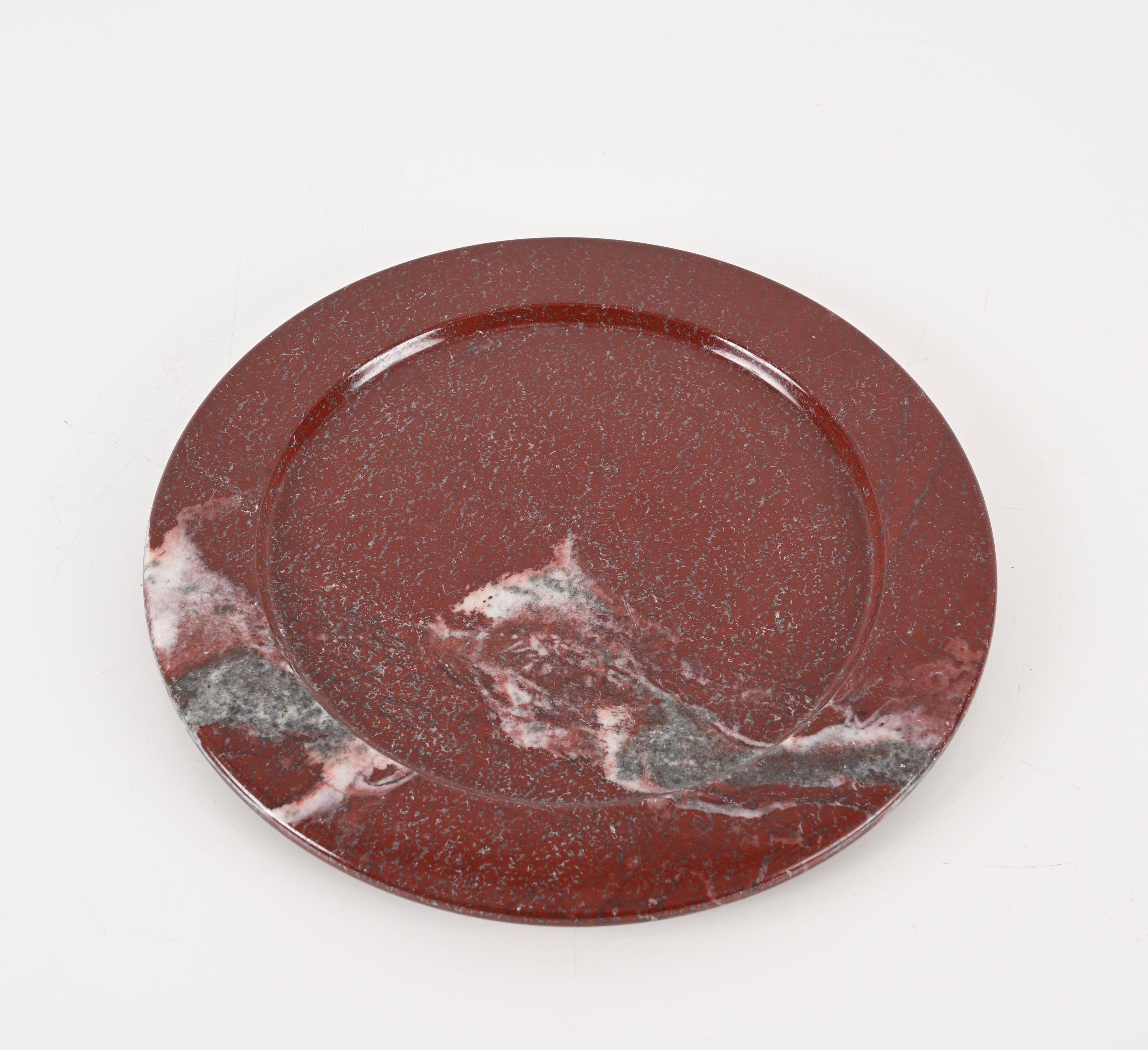 Magnificent solid dark red Porphyry marble plate made in Italy during the 1950s.

The simplicity of this plate enhances the quality of the marble used on this object, which is astonishing. In Ancient Rome the phorphyry marble was used in nobles