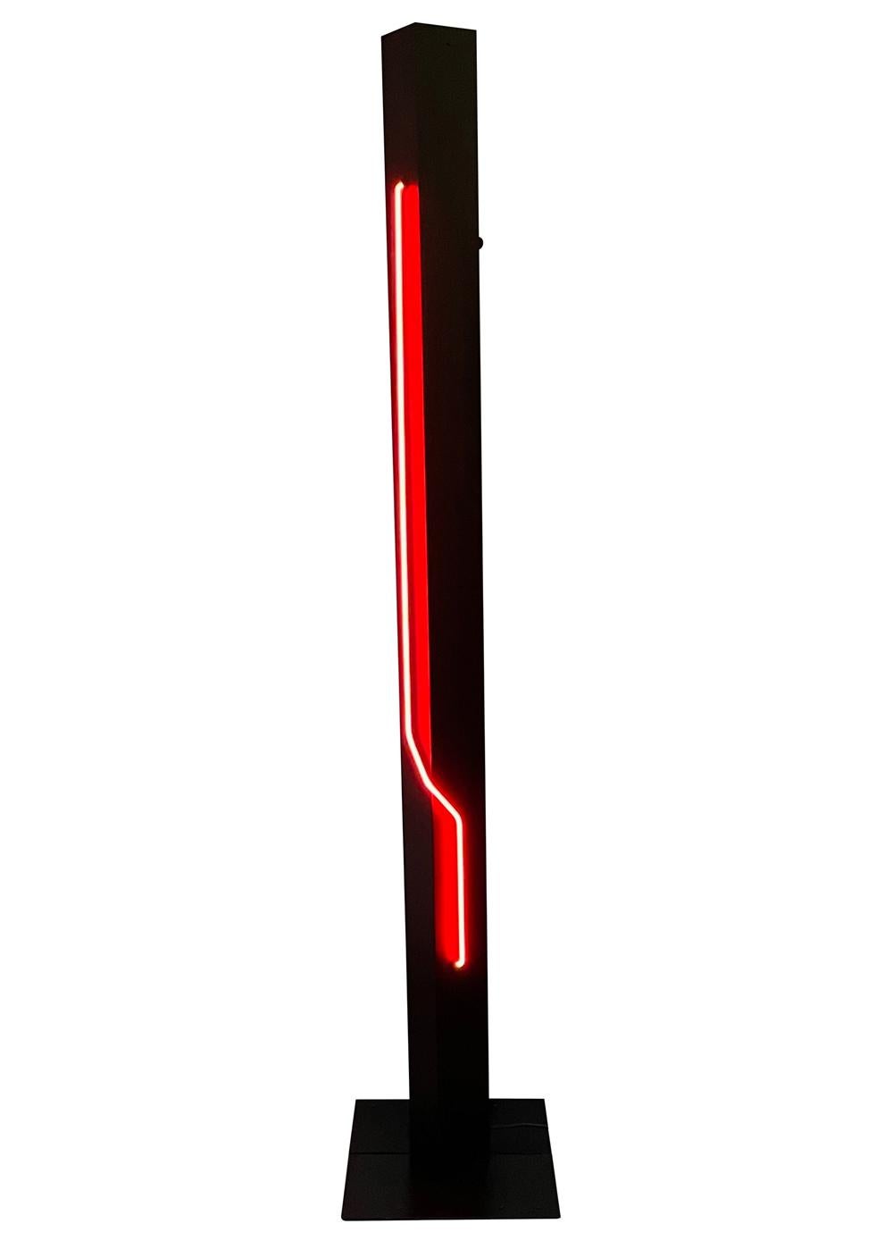 A tall post modern neon floor lamp made by Rudi Stern circa 1970's. It features black enameled steel construction, red neon lamp, and top torchiere light.