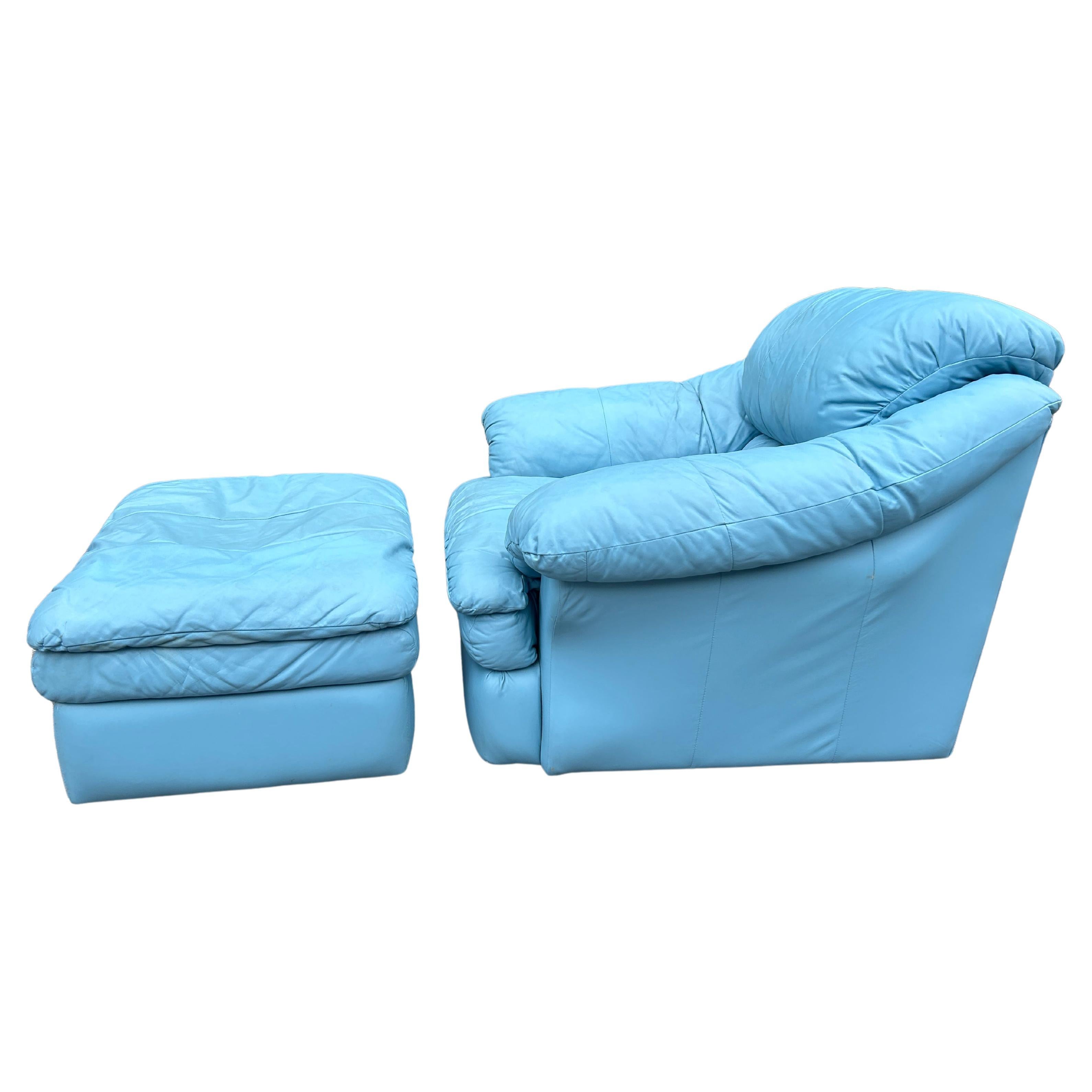 Clean mid century post modern Sky Blue soft leather puffy cloud lounge chair with ottoman  circa 1980. This chair is a time capsule from the 1980s/1990s with puffy side arms and back cushions wide lower cushion. The chair and ottoman anre all