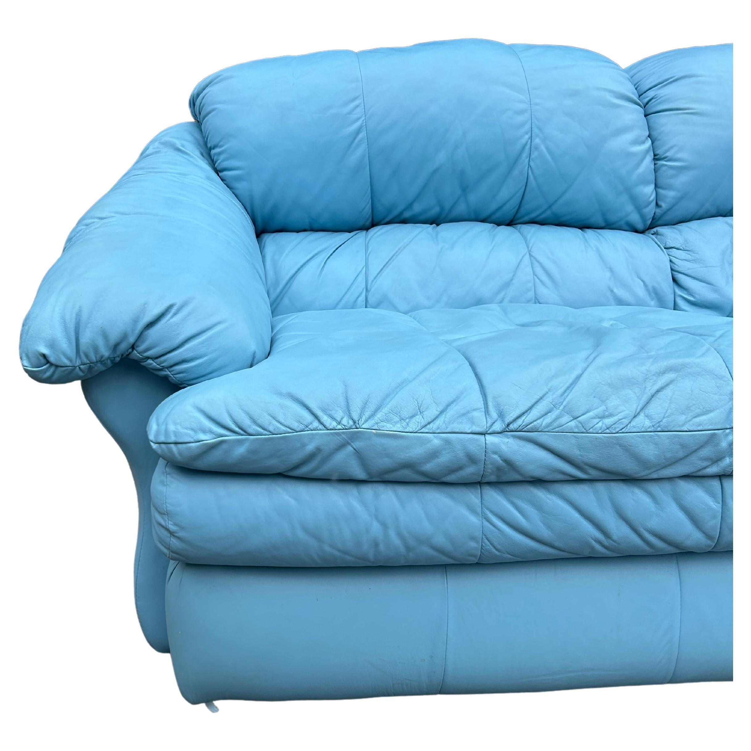 Clean mid century post modern Sky Blue soft leather puffy cloud sofa circa 1980. This sofa is a time capsule from the 1980s/1990s with puffy side arms and back cushions and 2 wide lower puffy cushions. The sofa is all original in very nice