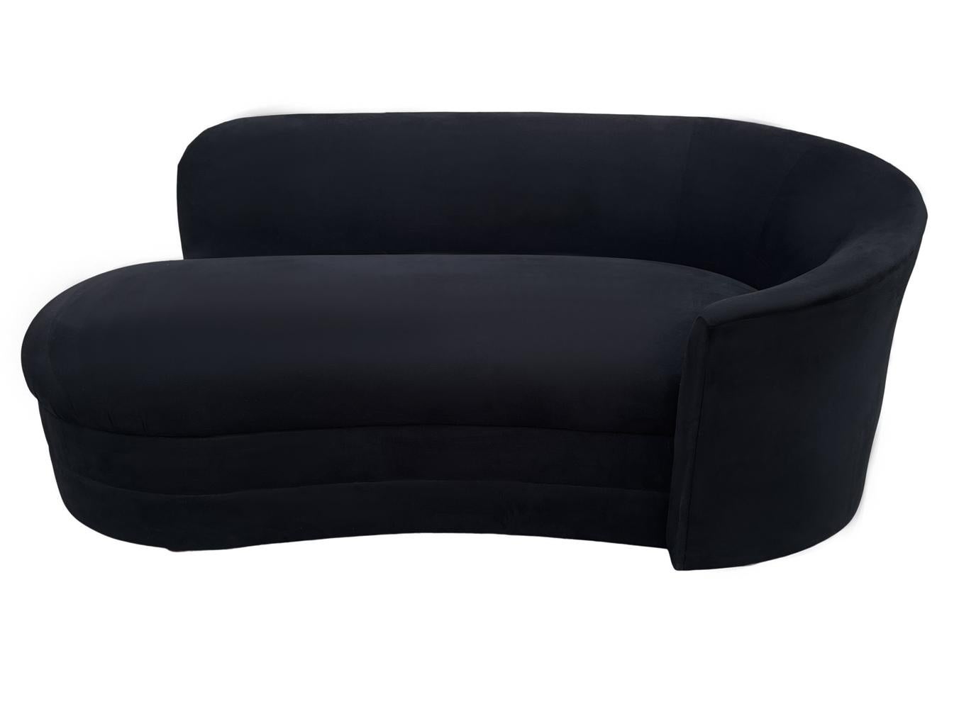 A sleek contemporary chaise lounge circa 1980's. This well made sofa retains its's original black velvet like upholstery. Its in very clean condition and usable as it is.