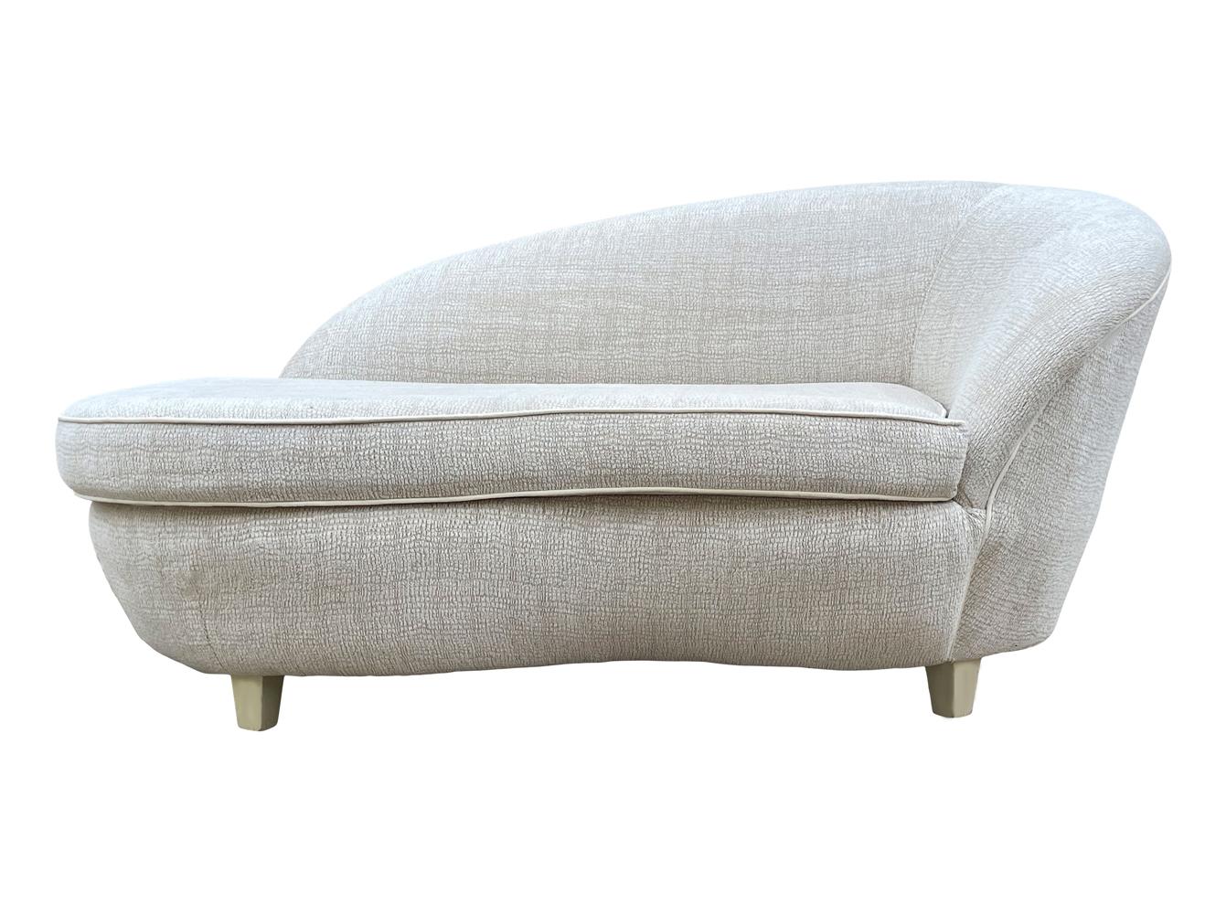 A beautiful modern design chaise lounge. It features beige wood legs with it's original upholstery. The fabric will need updating. Padding and foam are excellent.