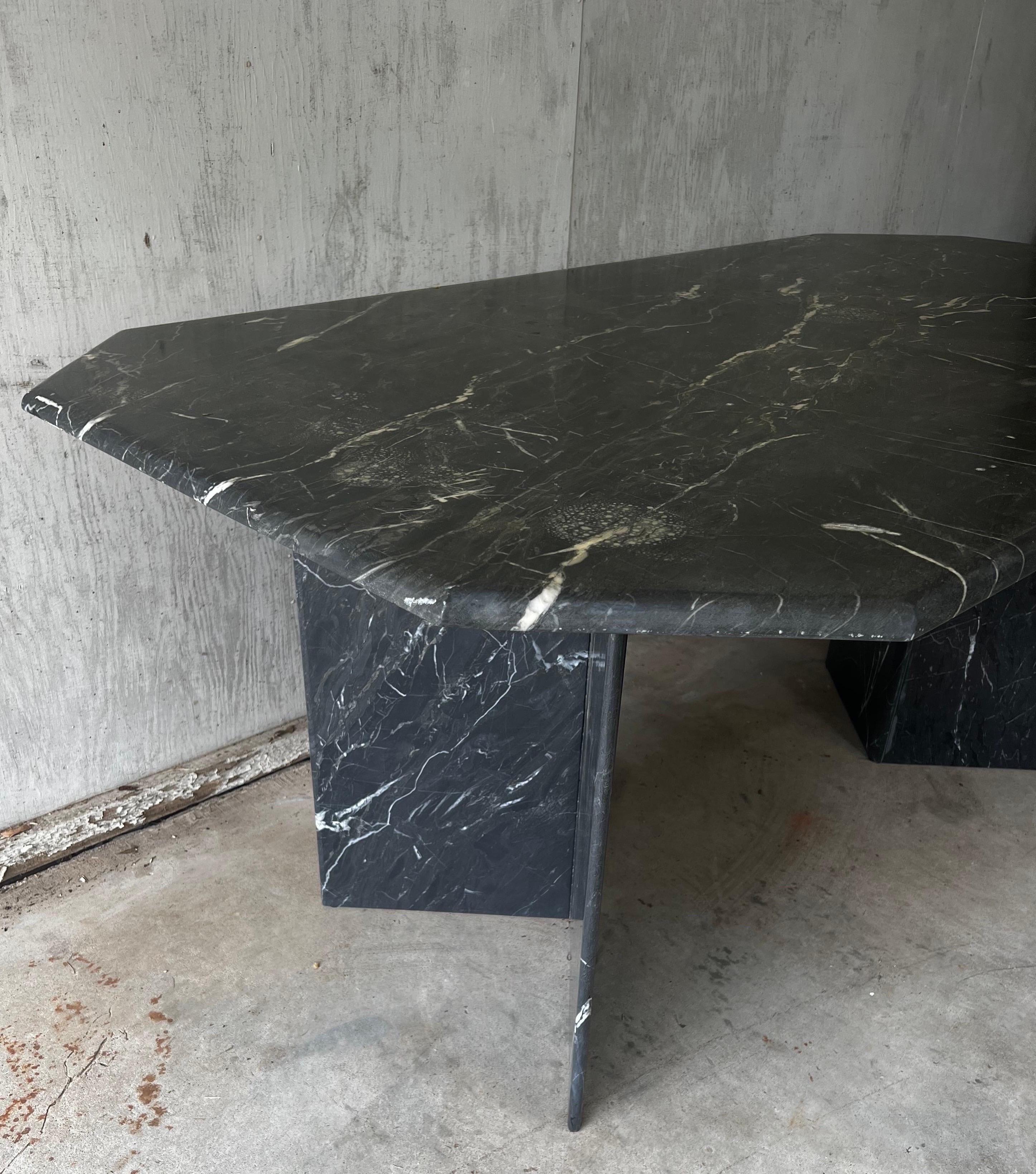 Gorgeous Mid-Century Modern dinging table styled after Angelo Mangiarotti.
Shades of black and grayish/green with white veining. Each corner has a 45-degree angle. 

Could also make a large desk as it sits on two pedestals that could be arranged