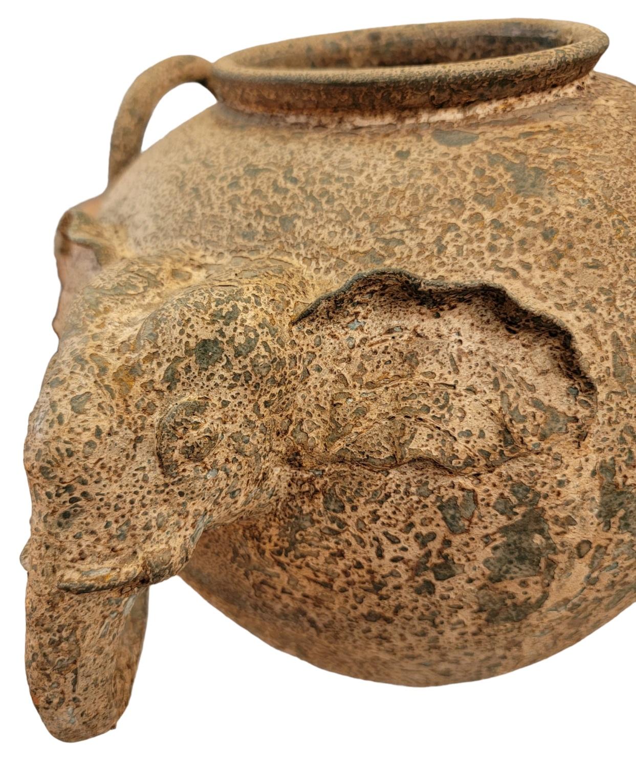 Mid century Pottery Elephant Head Vase. Great texture throughout the entire vase. Wonderful earth tone colors. Both handles have t he same texture. 

Measures approx -  12w x 15d x 12h
