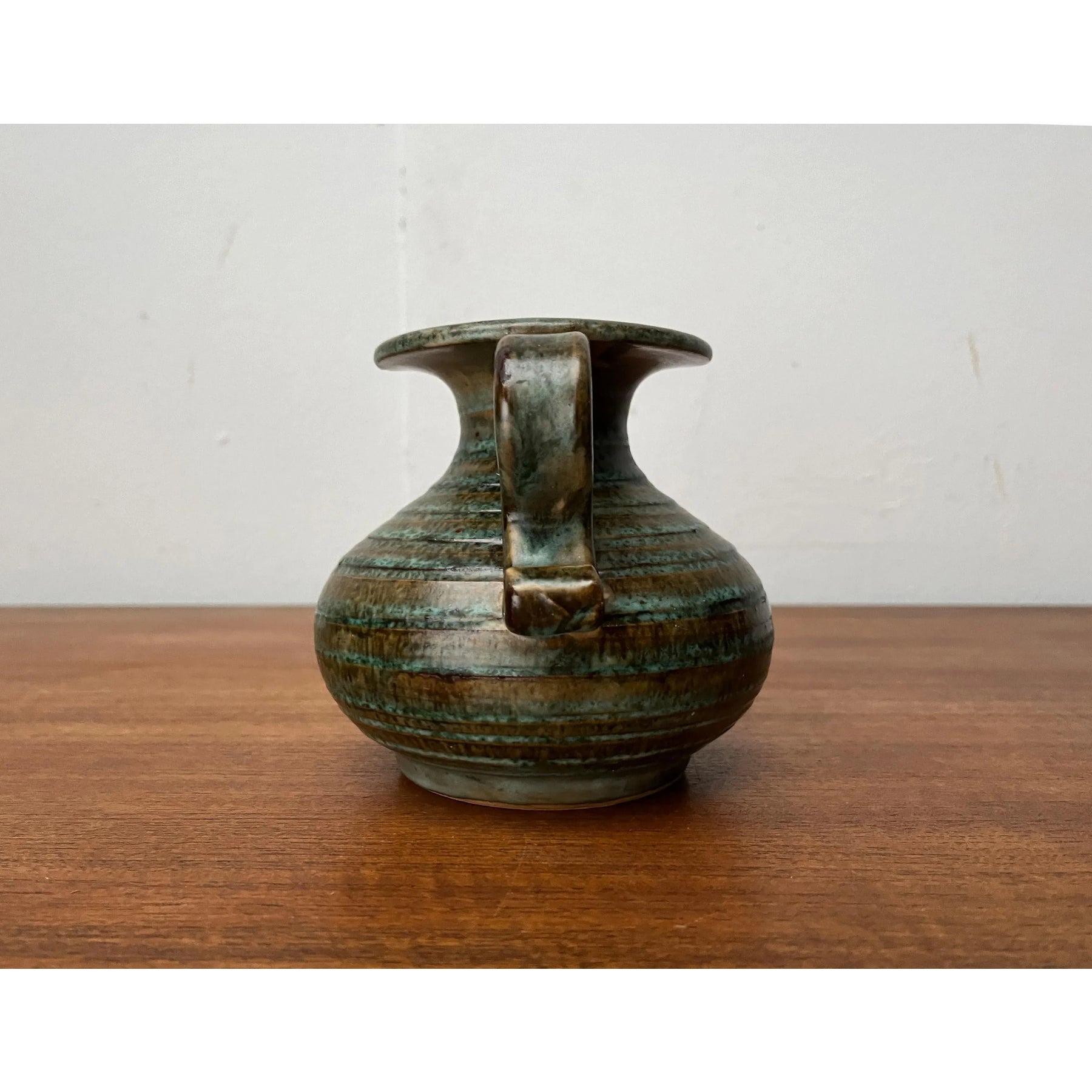 Mid-Century Pottery Jug, 1960s, in Very Good conditions. Designed 1960 to 1969.

Additional information:
Materials: Ceramic
Color: Brown
Styles: Mid-Century Modern
Item Type: Vintage, Antique or Pre-owned
Dimensions: 5.91ʺW × 5.51ʺD ×