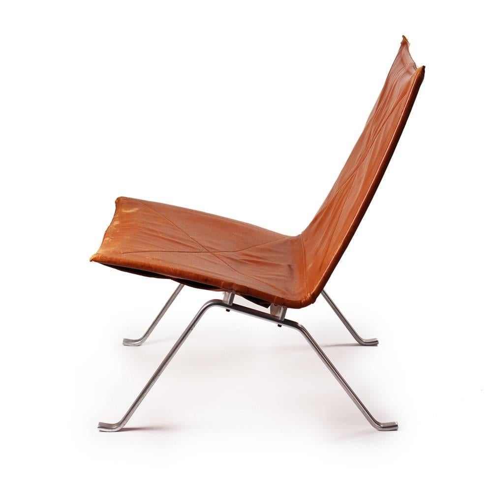 Original first edition PK 22 low chair designed 1956. Cognac leather seat on stamped polish steel frame. Poul Kjaerholme was one of the leading post war Scandinavian designers.
Frame impressed with Manufacturers Mark.
  