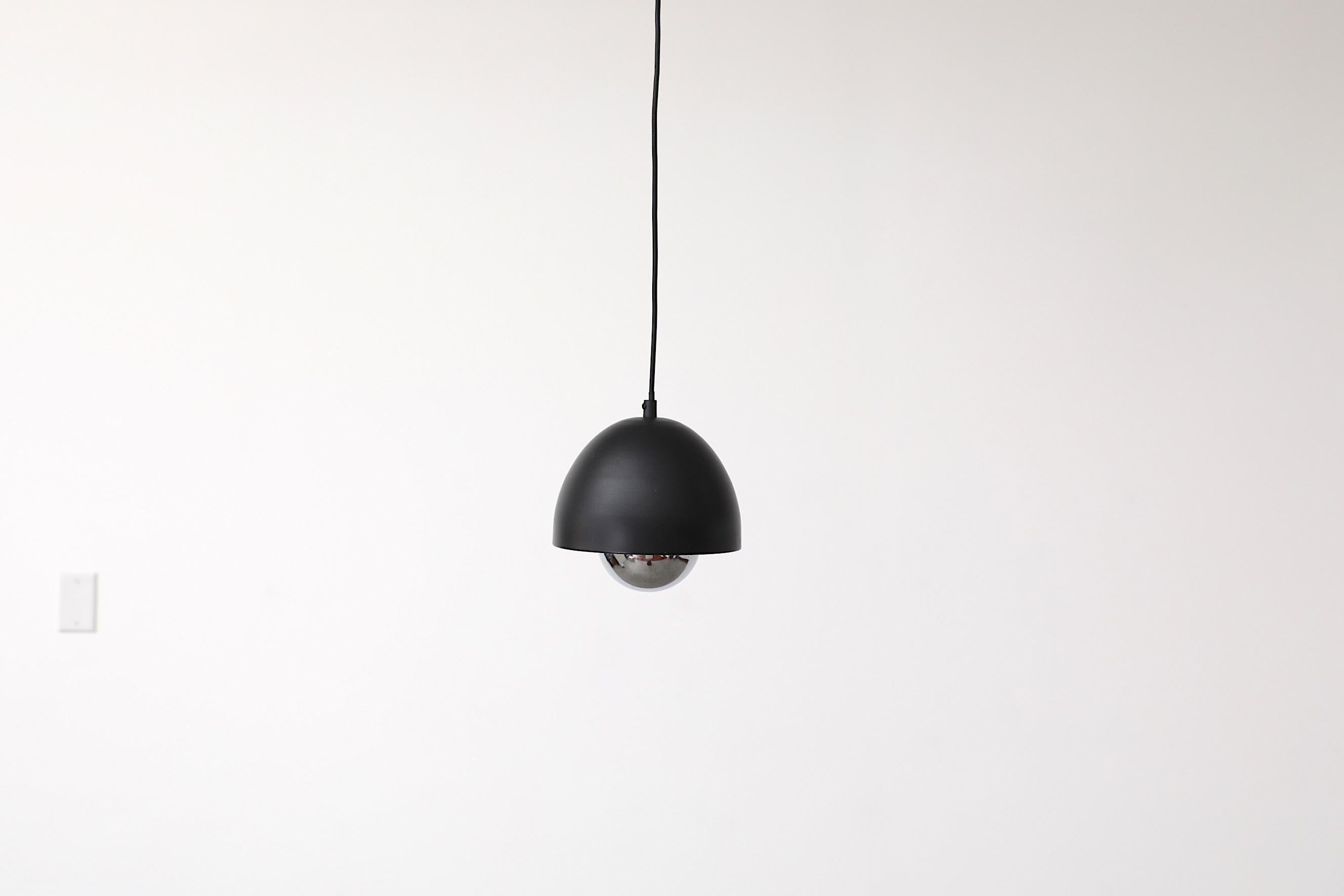 Cute little Poulsen style pendant light. Shade is matte black and dome shaped, chrome diffuser is suspended in the center underneath the bulb. In original condition with visible wear, including scratches. Wear is consistent with its age and use. 