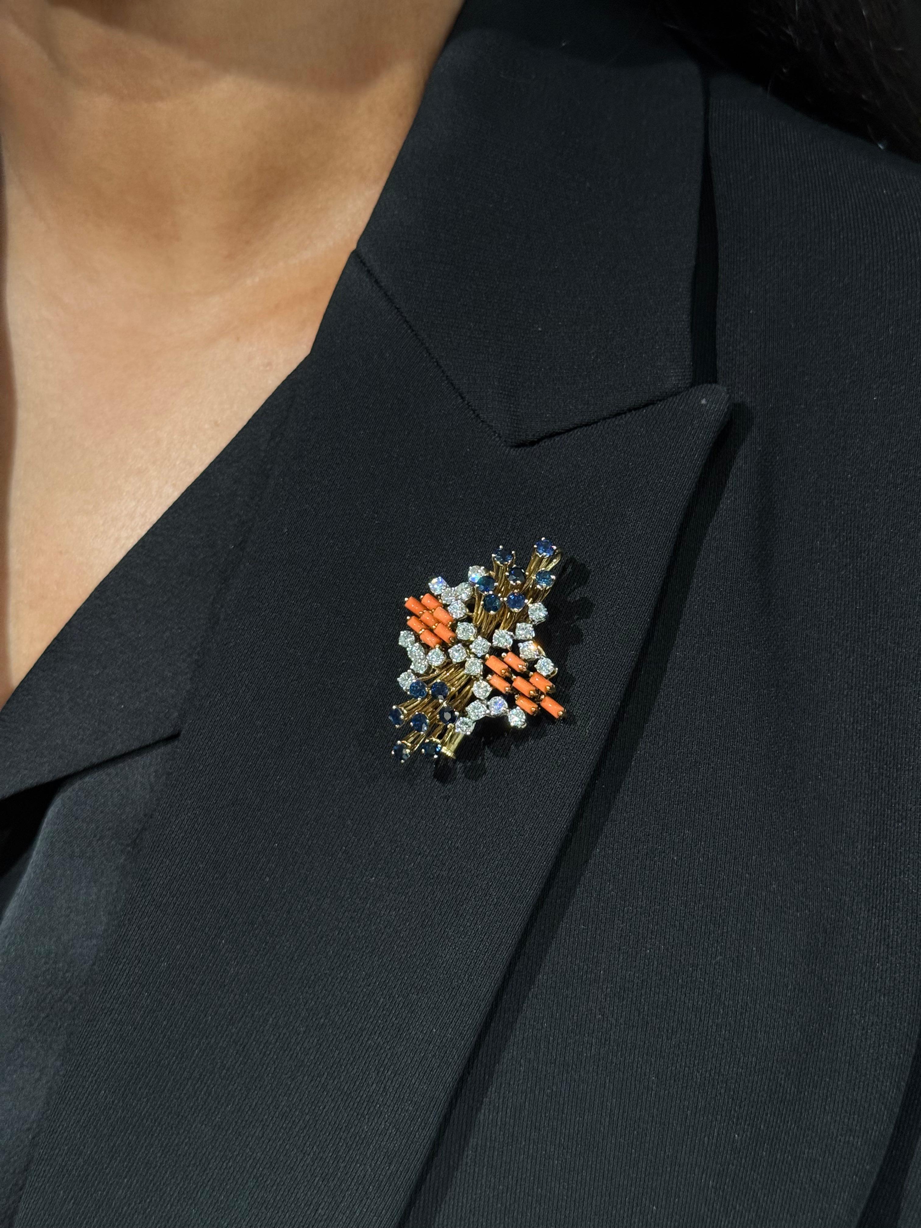 Mid-Century Precious Coral, Sapphire and Diamond Convertible Pendant/Brooch in 18K Gold, circa 1960s. Bold. Brilliant. Radiant from every angle.

This striking brooch–pendant hybrid is a sculptural celebration of postwar optimism and unapologetic