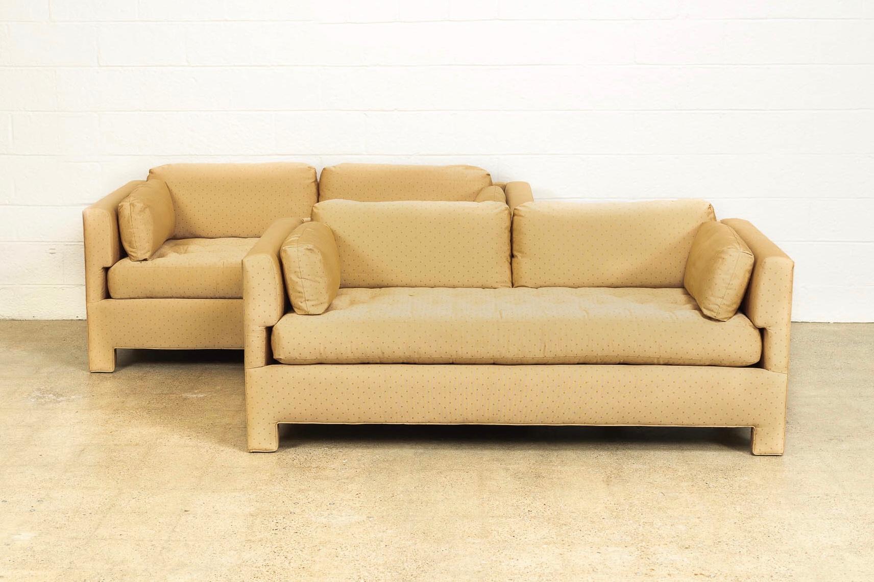 This pair of vintage Mid-Century Modern sofa couches in the style of Harvey Probber or Edward Wormley are circa 1960. With Classic midcentury styling, the sofas have an elegant profile with clean, Minimalist lines. The couches have one long button