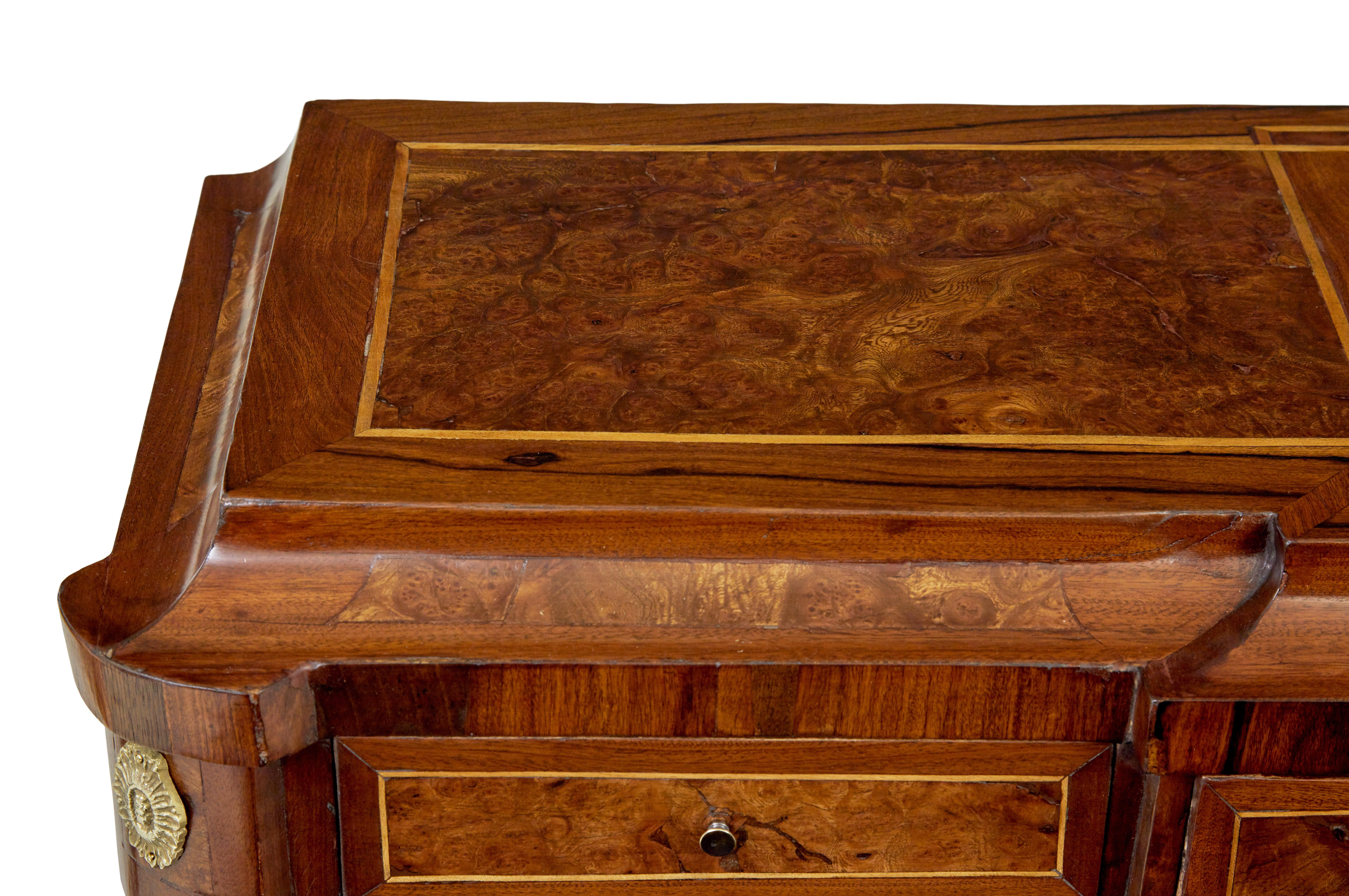 Mid century profusely inlaid walnut sideboard circa 1960.

Unusual sideboard which is heavily inlaid, strung and decorated with brass mounts and beading.

Shaped top with 3 over lapping strung squares, below the top surface are 3 shallow drawers