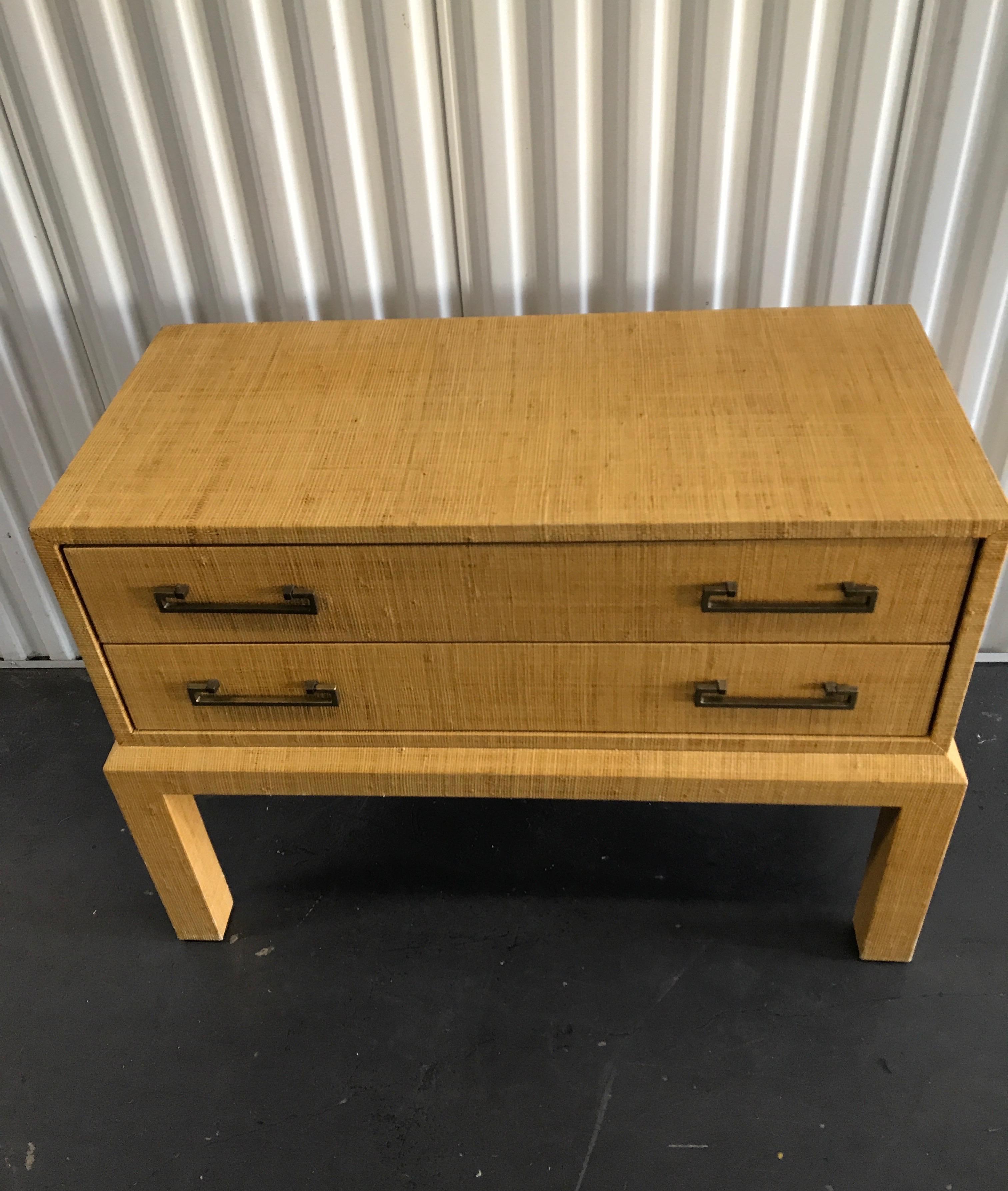 Raffia covered two-drawer chest or side table with brass pulls.