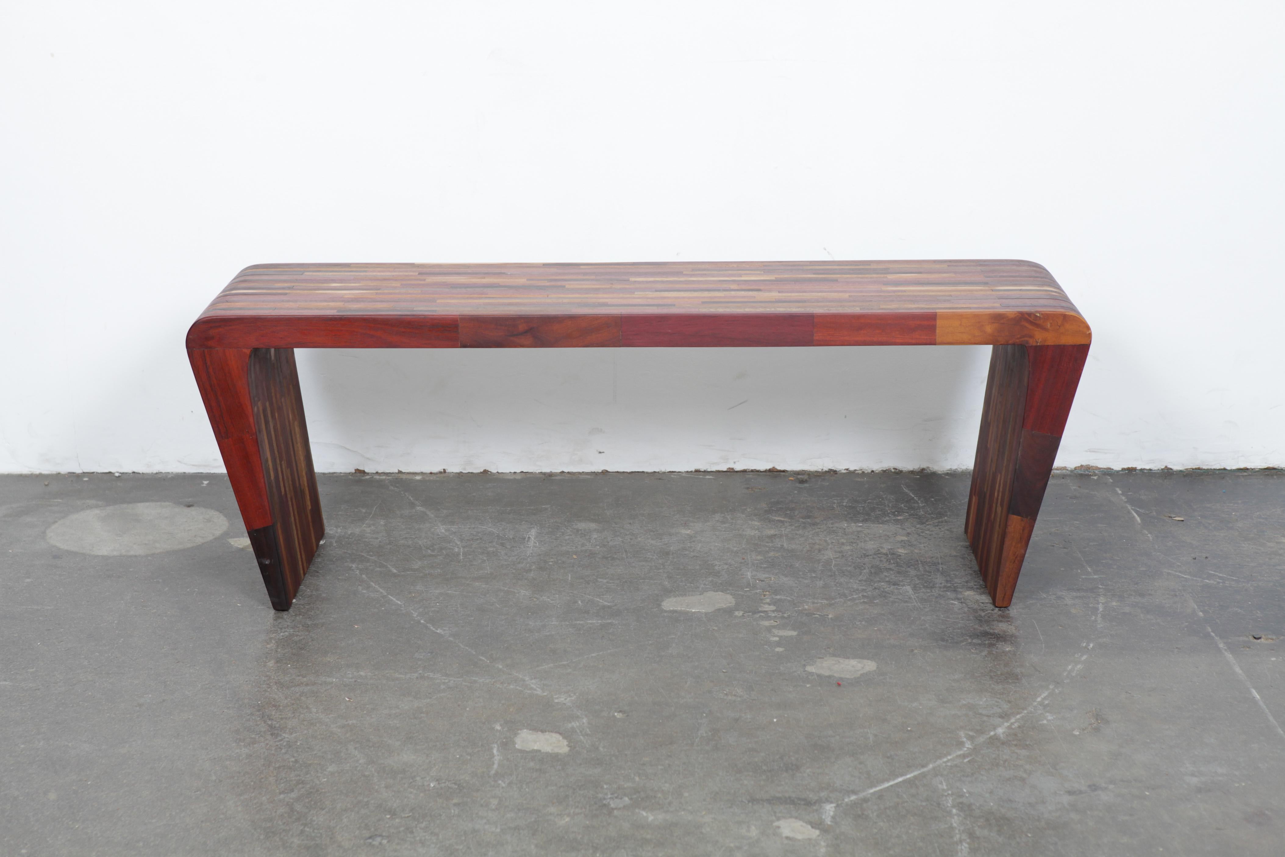 A one-of-a-kind sculptural solid Jatoba console table by artist Tunico T. Table has tapered, angled sides, made from naturally felled wood, Brazil, 2000s.