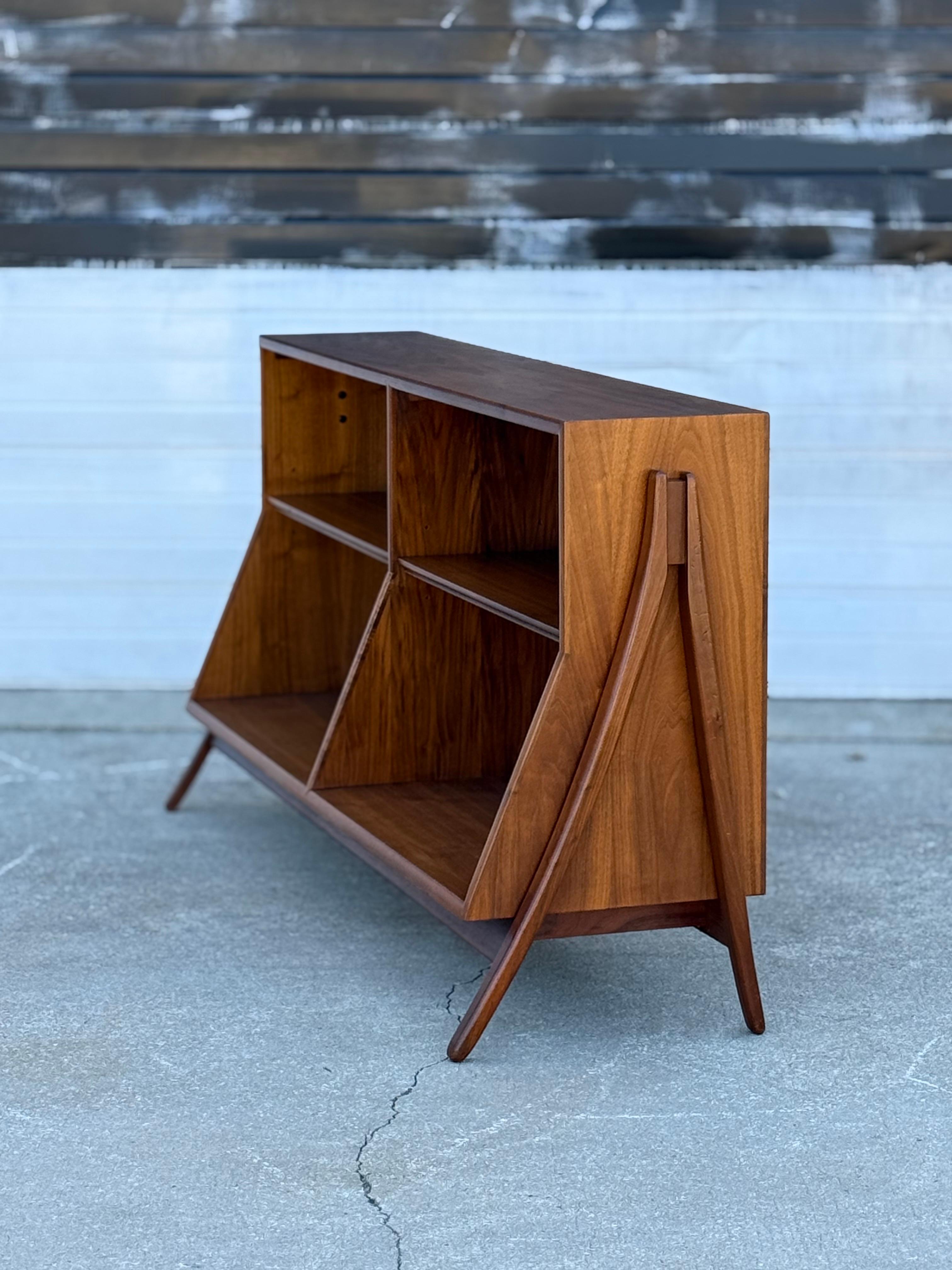Pleased to offer this seldomly seen mid century Drexel Declaration walnut book case. Designed by Kipp Stewart in the 1950’s. This item has always been a bucket list item and we are so excited to have one in stock. Iconic design by one of the best